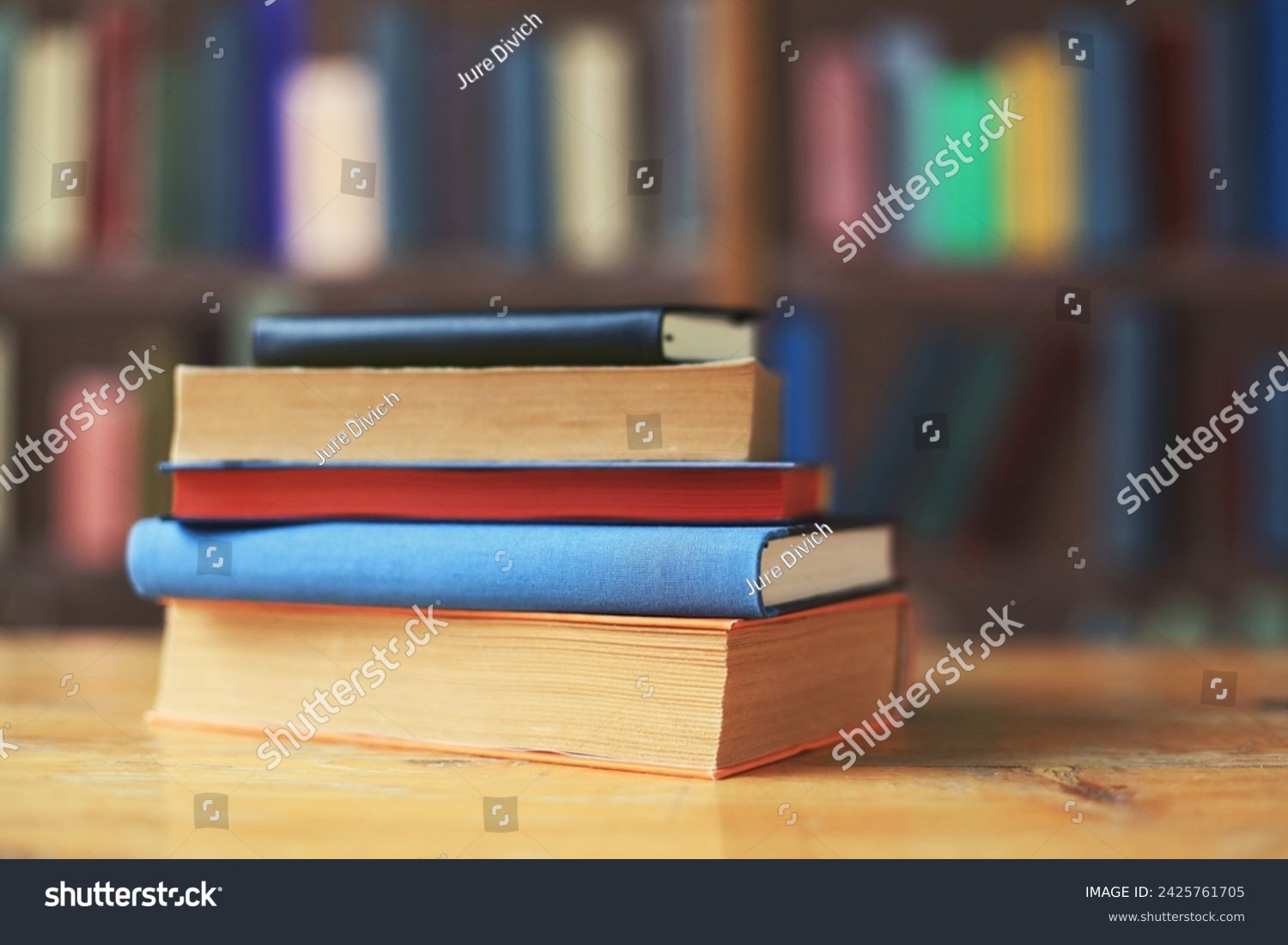 A collection of history books and encyclopedias on a table in the library #2425761705
