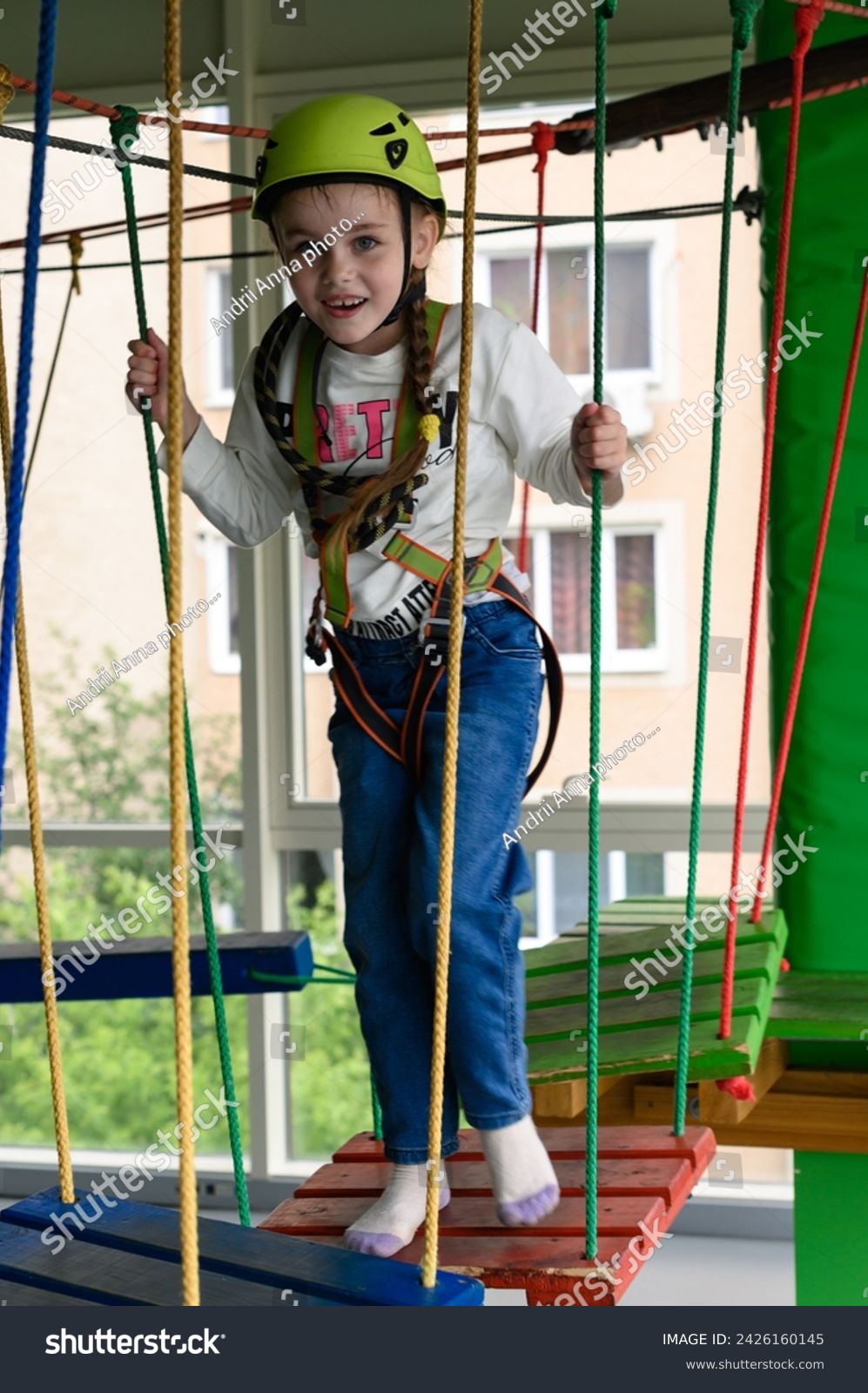 Children's cableway in the playroom, little girl passes the cableway, active and physical development of the child. #2426160145