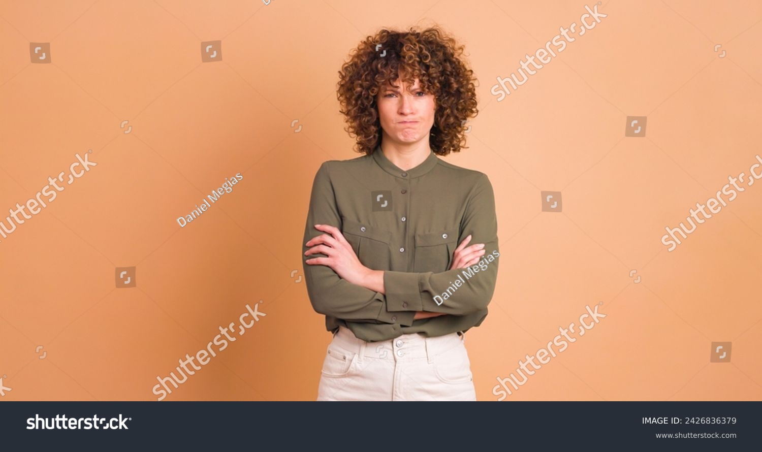 Disagreeing young woman with twisted mouth on beige background #2426836379