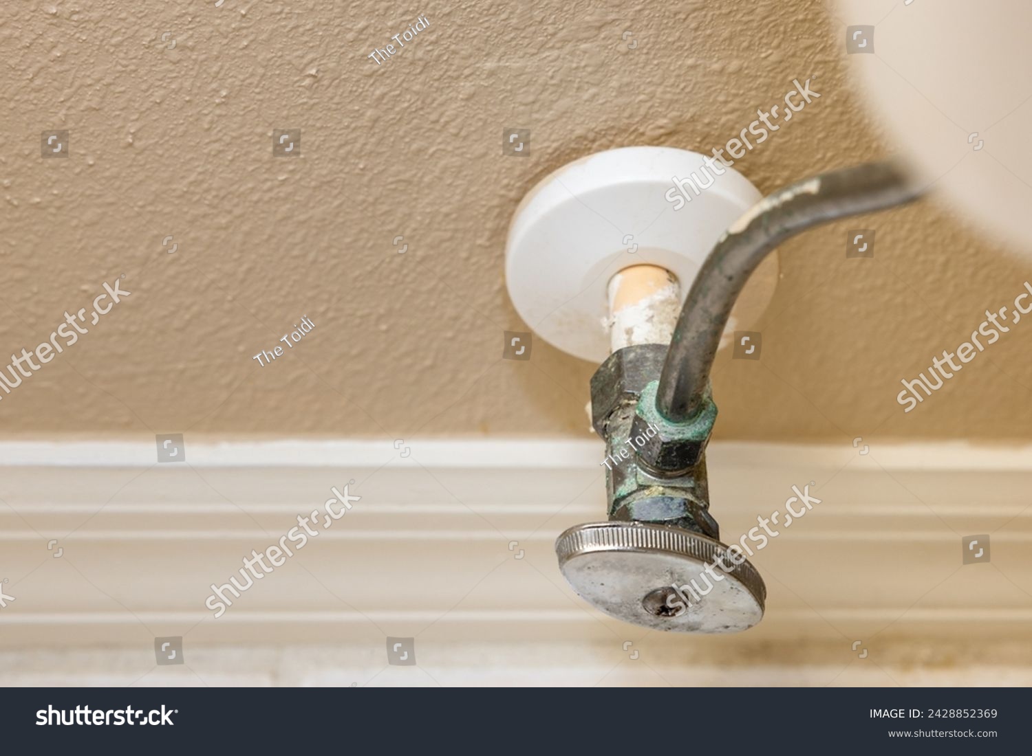 Residential home bathroom toilet water shut off valve. Replacing old leaking restroom wall supply line valve plumbing. #2428852369