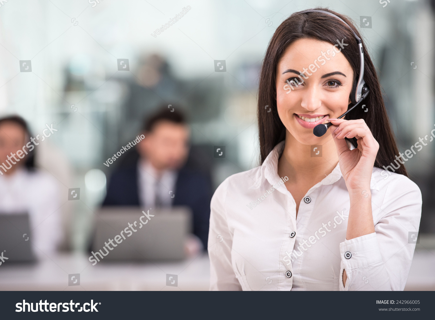 Portrait of happy smiling female customer support phone operator at workplace. #242966005