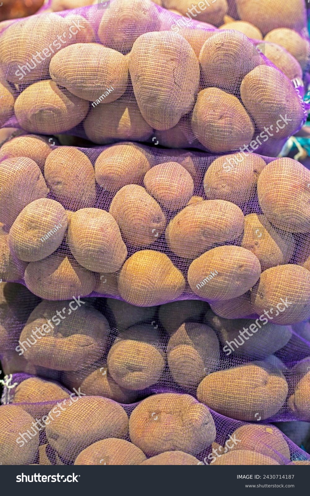 pre-packed varietal potatoes in nets in the supermarket #2430714187
