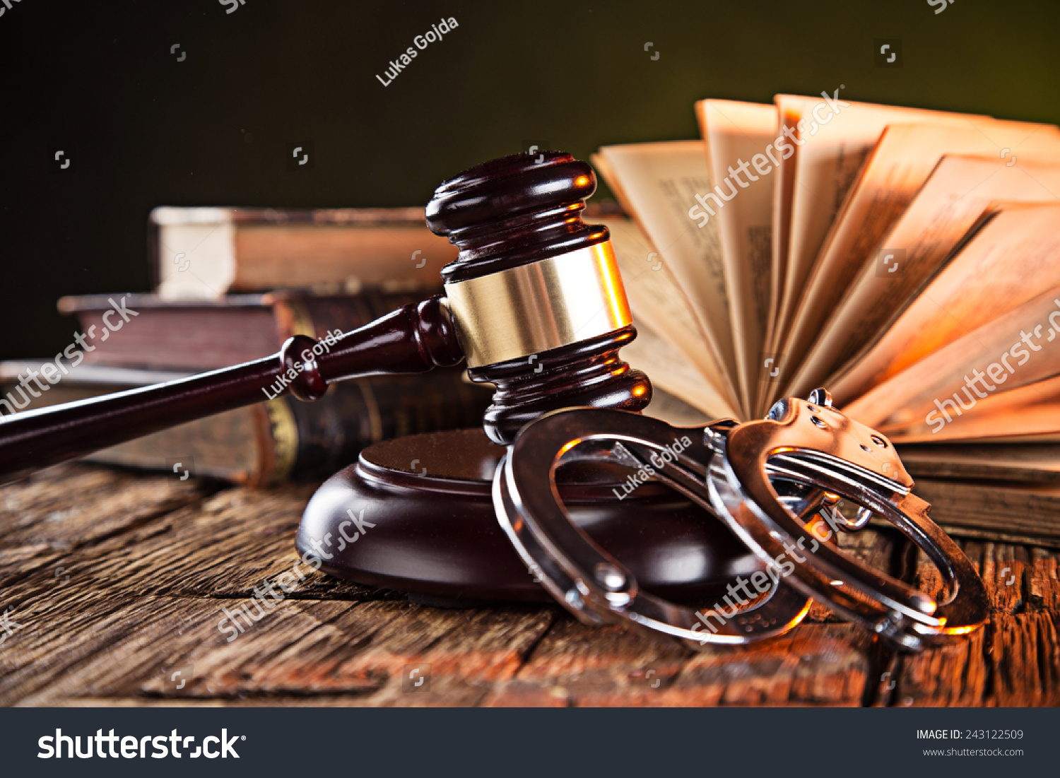 Wooden gavel and books on wooden table, law concept #243122509