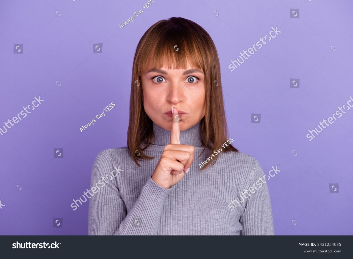 Portrait of young attractive brunette woman with sincere emotions wearing casual shirt for mockup isolated on bright background with copy space and showing shh gesture. #2431254035