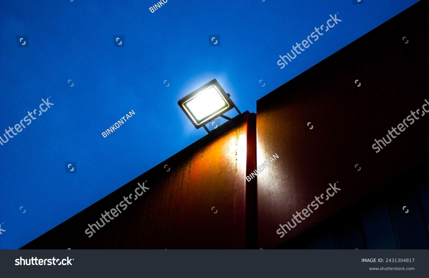 Spotlight, LED lamp, industrial glowing lantern on the wall of a building at night. #2431304817