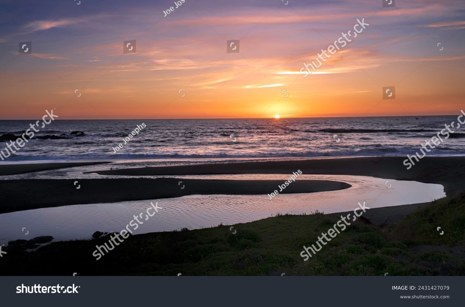 Sundown on California's scenic Central Coast. Water flowing into the ocean is from inland streams overflowing from heavy winter rains #2431427079