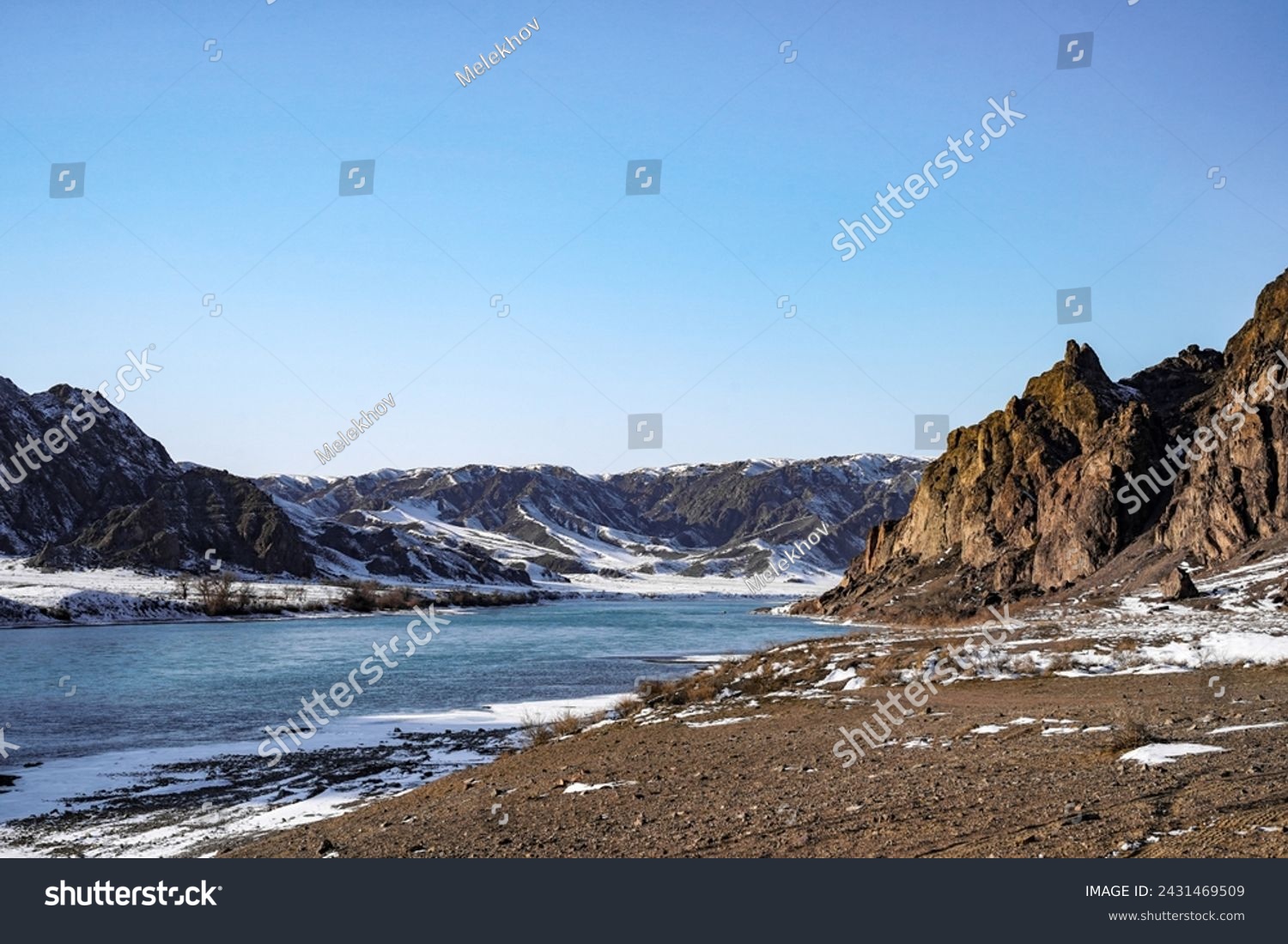 
The river froze, forming an icy panel that stretches between the rocks, like a silver bridge connecting the inaccessible cliffs on both sides. #2431469509