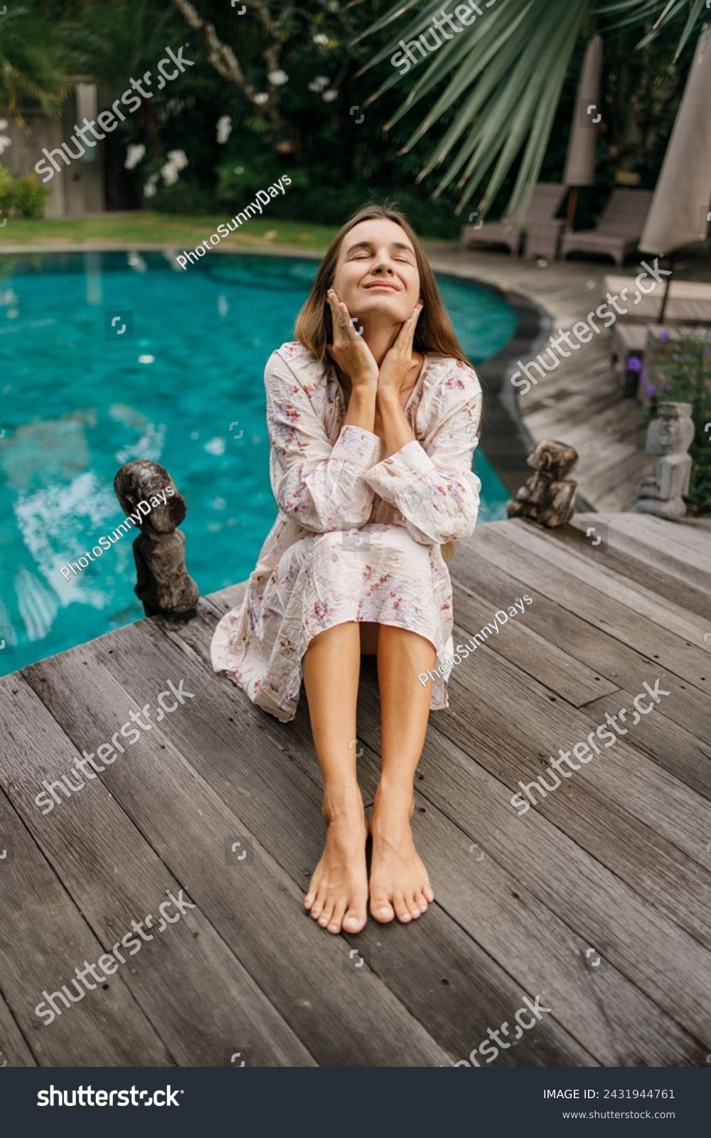 Beautiful caucasian lady in dressi sitting near swimming pool   at tropical summer resort, closed eyes, meditation #2431944761