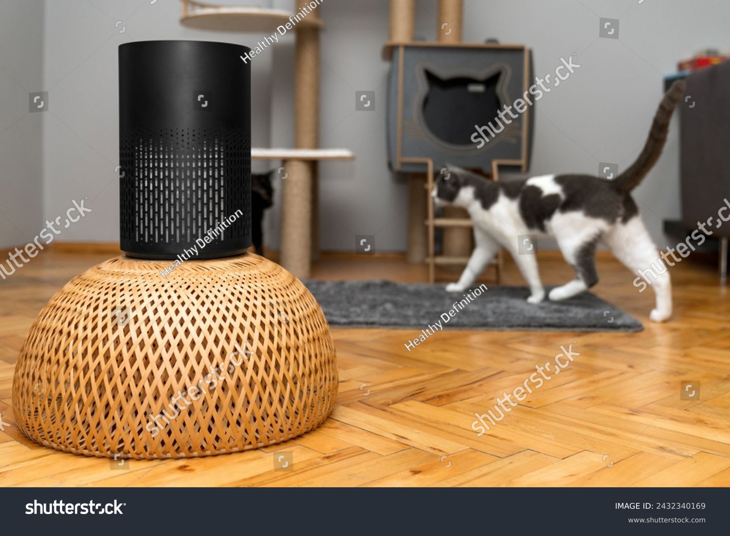 air purifier in the area with pets or cat. Air Pollution Concept. Air purifier, filters out invisible viruses, allergens or pollutants in the house on a cat tree background. Cute cat and Air purifier #2432340169