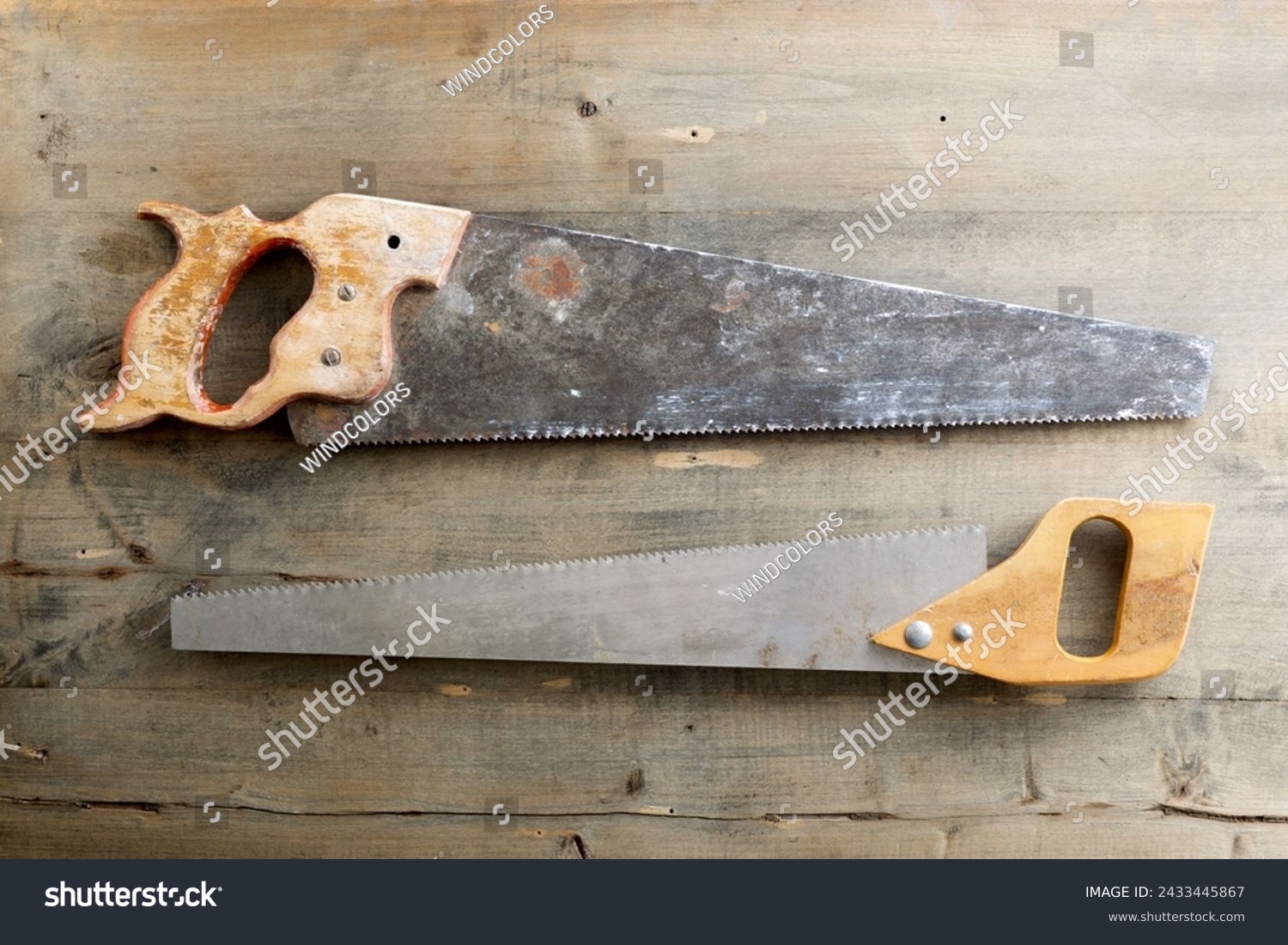 Close up of two disused handsaws on a work bench. #2433445867