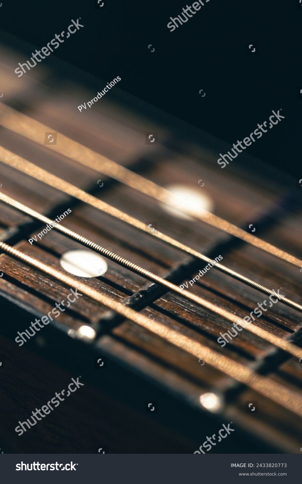 Part of an acoustic guitar, guitar fretboard on a black background. #2433820773