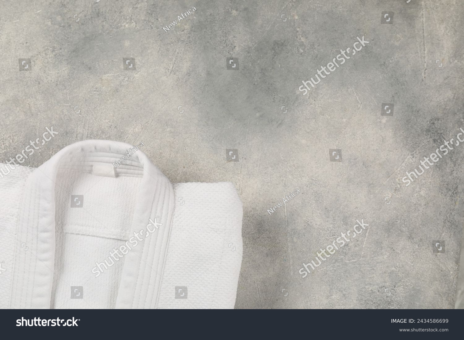 White kimono on gray background, top view. Space for text #2434586699