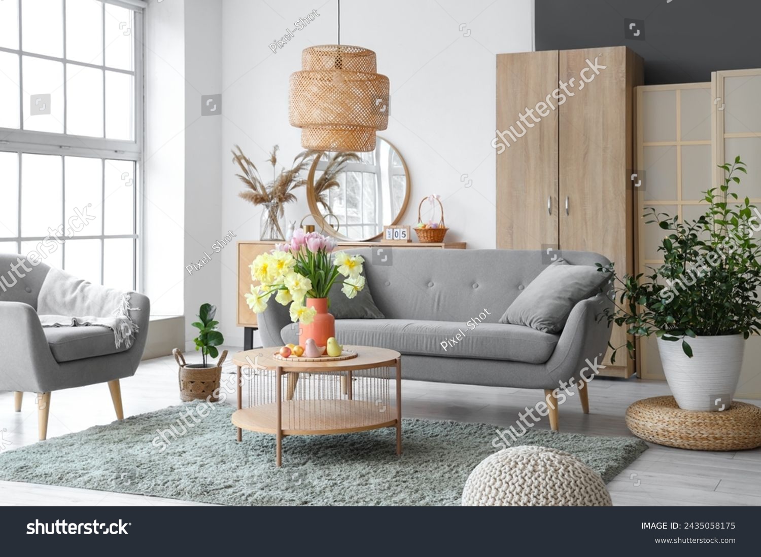 Interior of modern living room with flowers, Easter eggs and porcelain quails on coffee table #2435058175