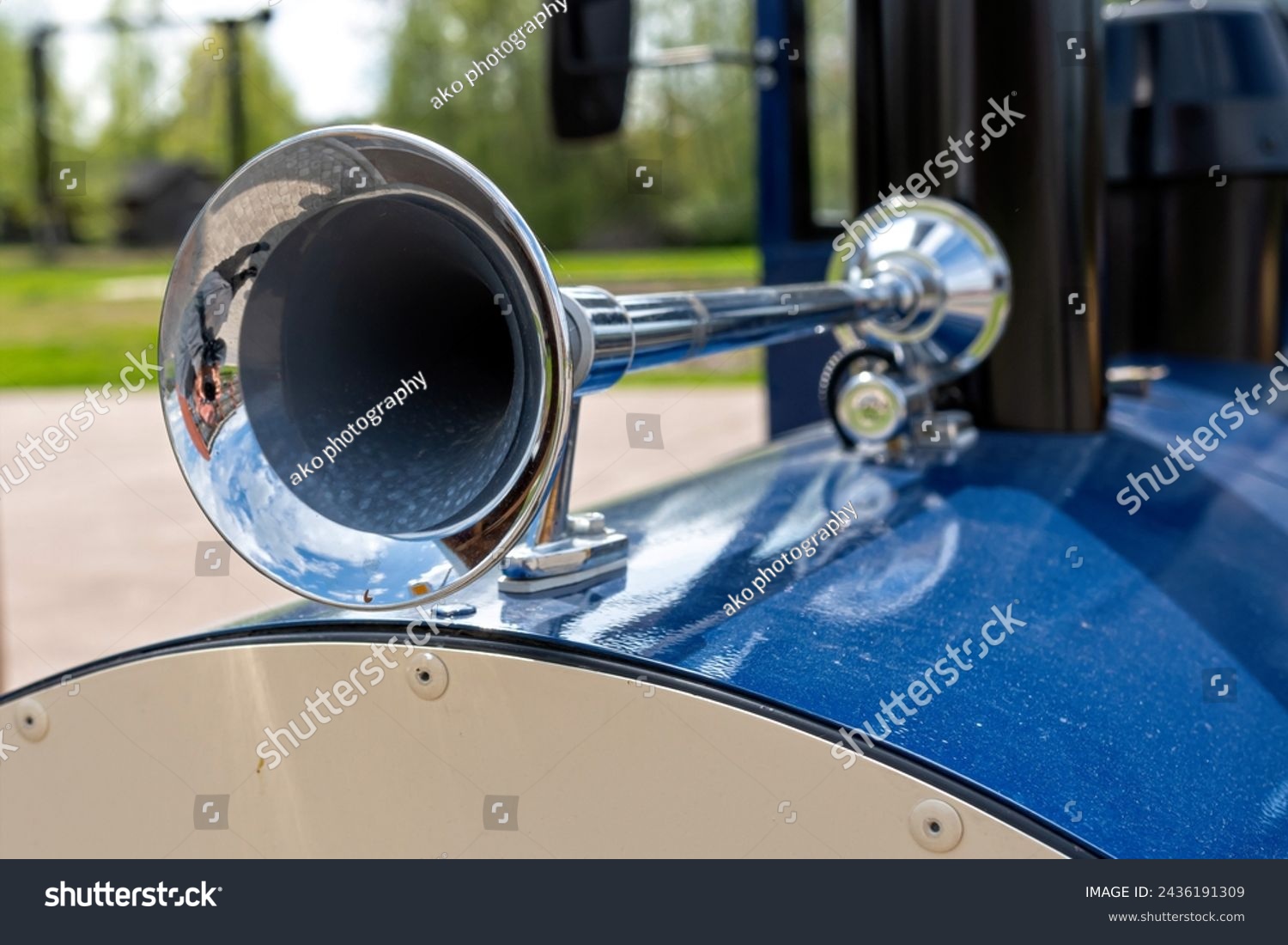 Close-up of the steel vintage signal horn on a blue car in the park, selective focus #2436191309