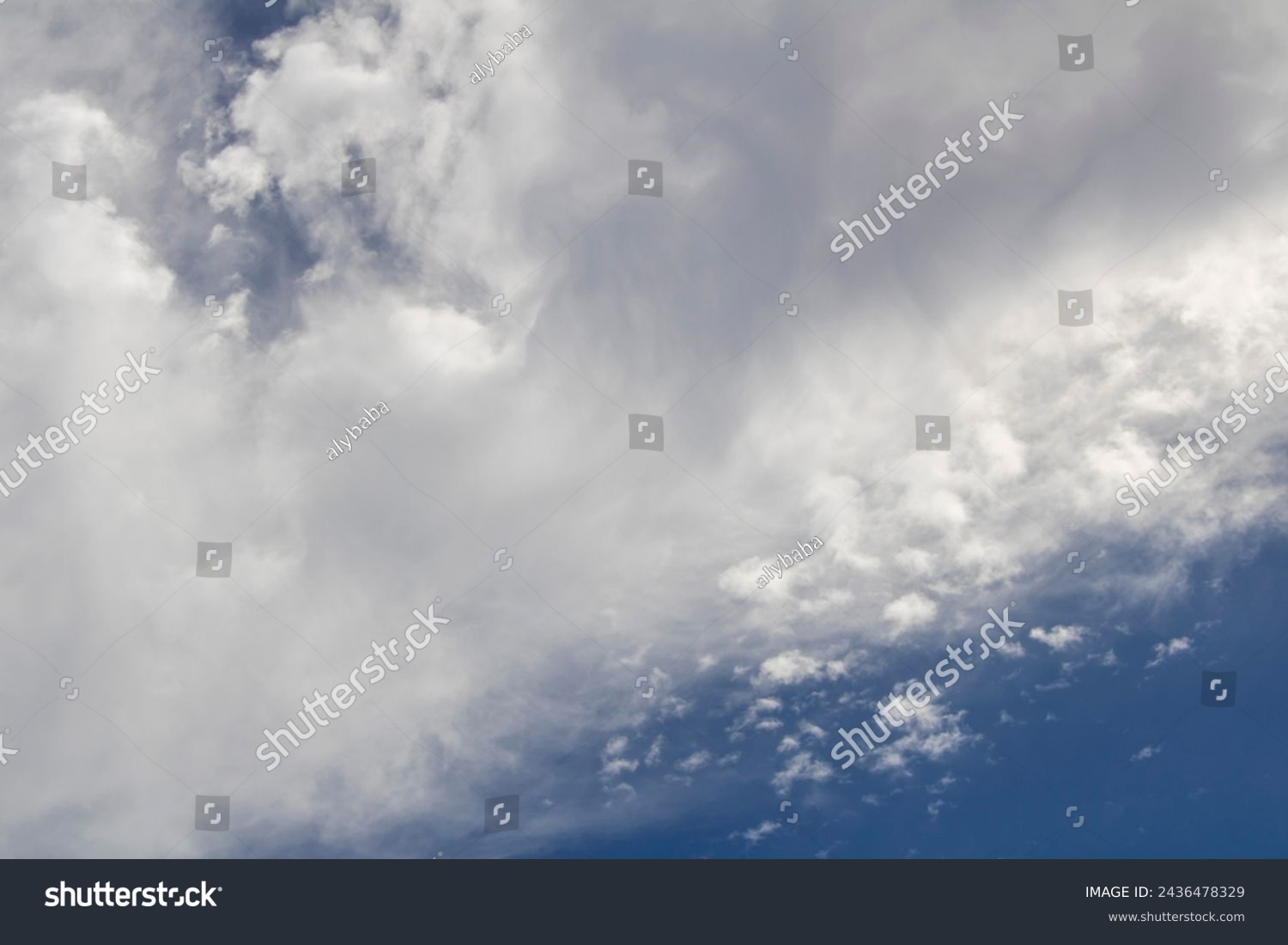 Fluffy white cumulus clouds with some cumulostratus formations on a late summer afternoon are contrasted against the azure blue Australian sky.  #2436478329