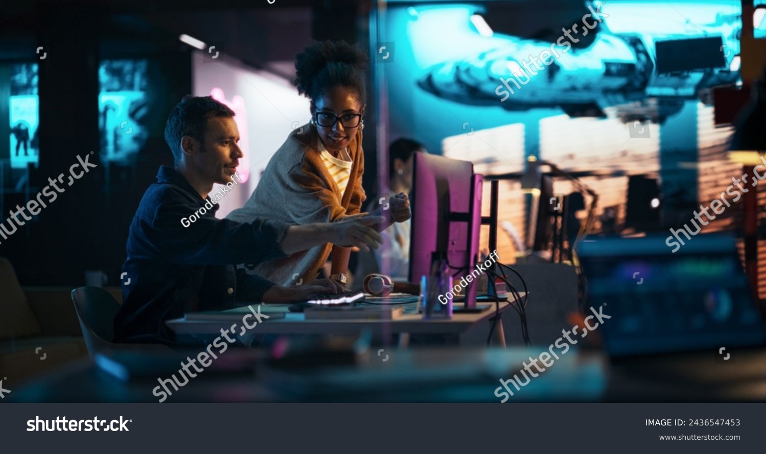 Portrait of Black Creative Director Giving Instructions on 3D Game Visuals to Male Developer in Creative Agency. Two Stylish Diverse Employees Discussing Design on Computer in Game Development Company #2436547453