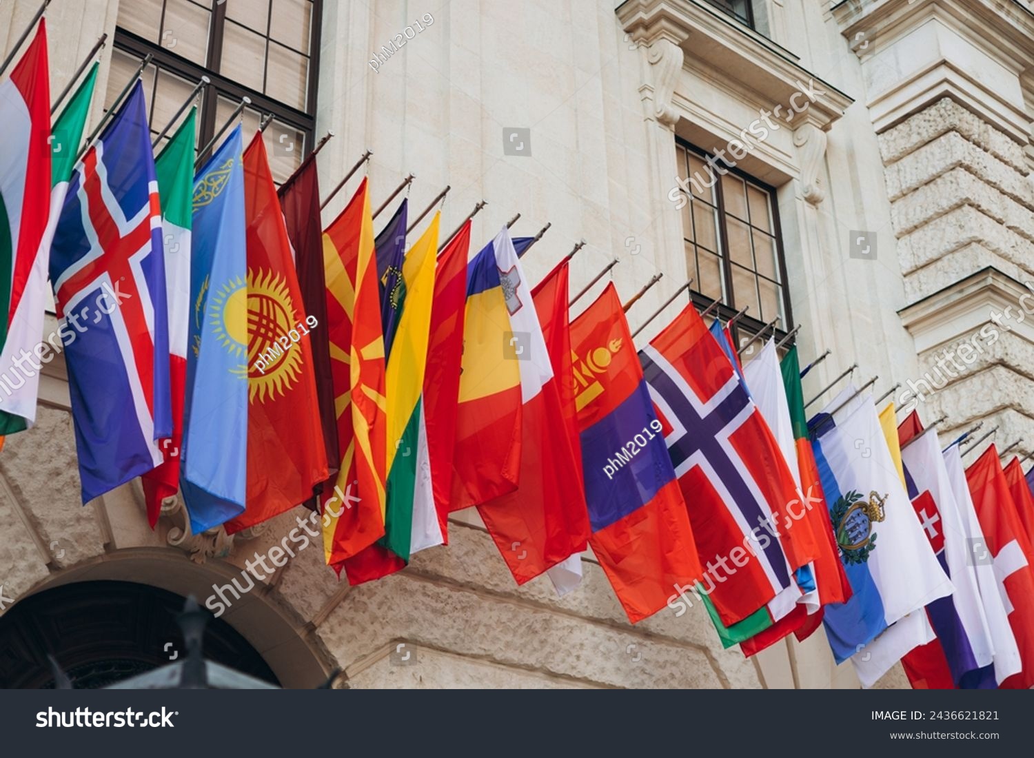 National flags of various countries flying in the wind. Colorful flags from different countries. Flags Organization for Security and Co-operation in Europe #2436621821