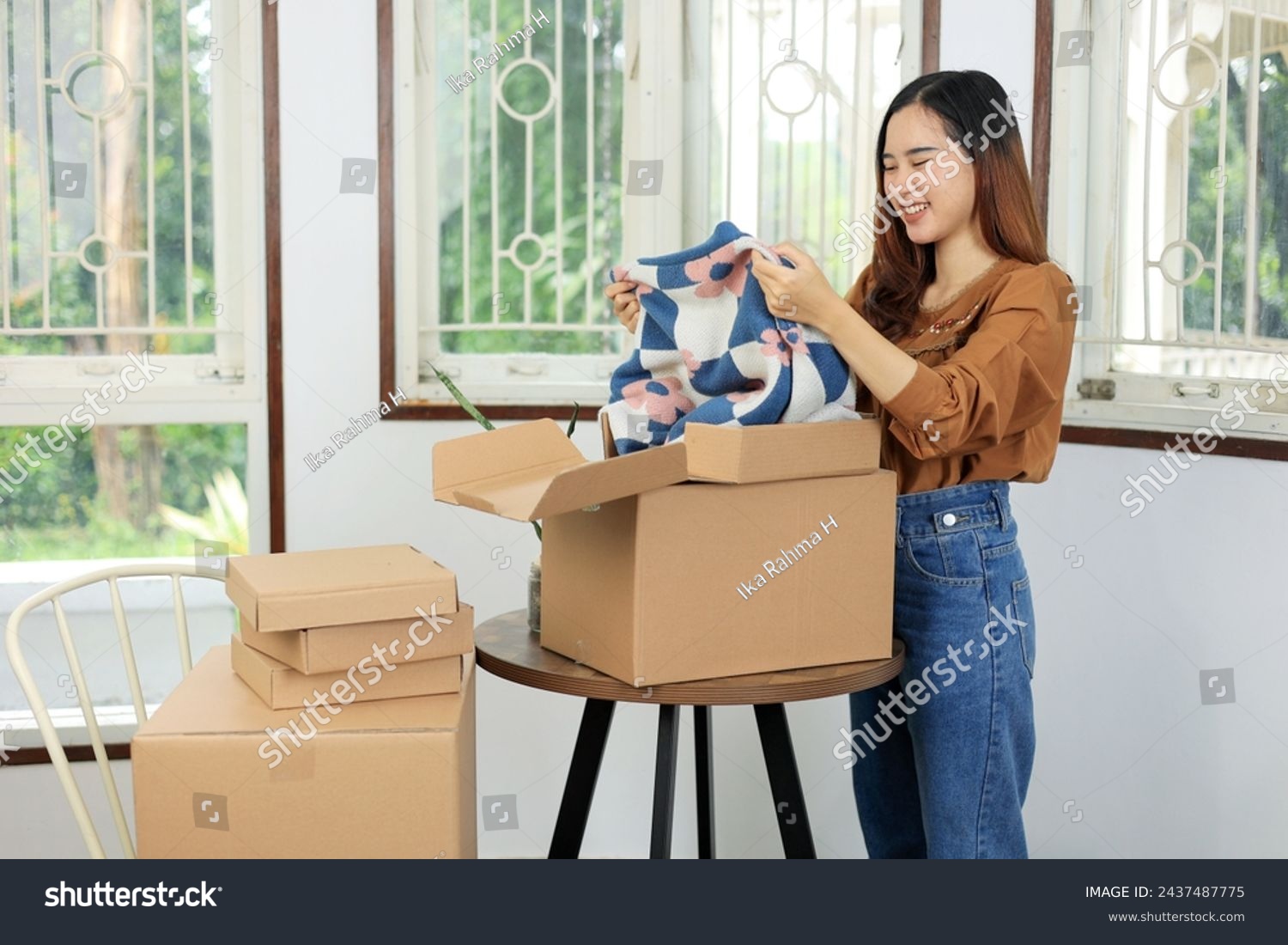 Asian Female Standing with Opened Cartoon Box, Unboxing Product from Online Store with Happy Face. Online Shopping Concept #2437487775
