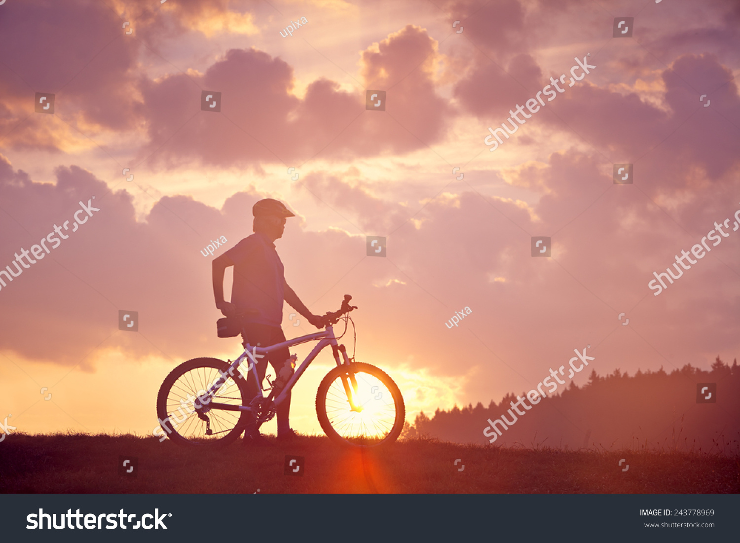 Man and mountain bike in the sunrise #243778969
