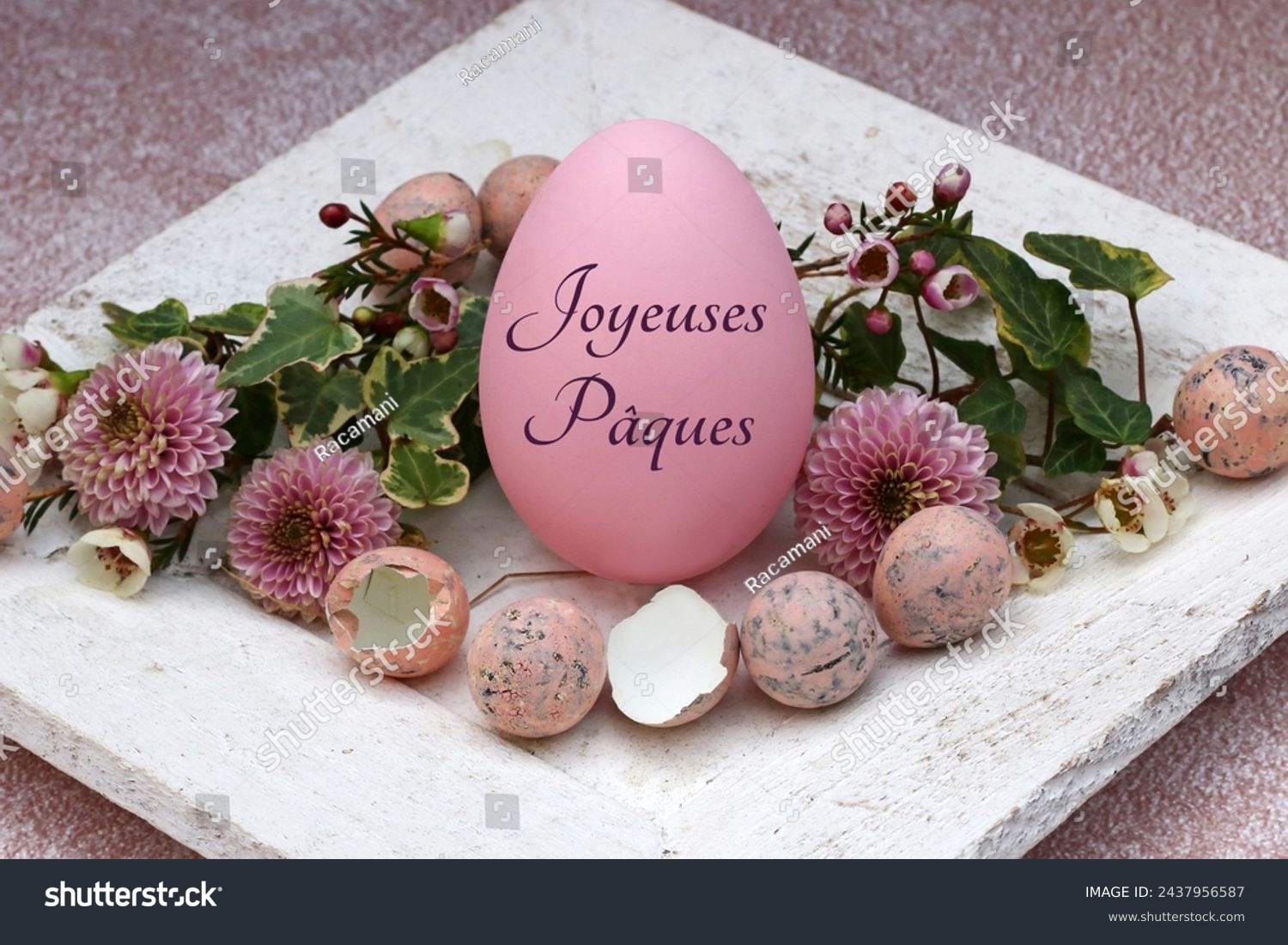 Greeting card Happy Easter: Inscribed Easter egg with quail eggs and flowers. French inscription translates as Happy Easter. #2437956587