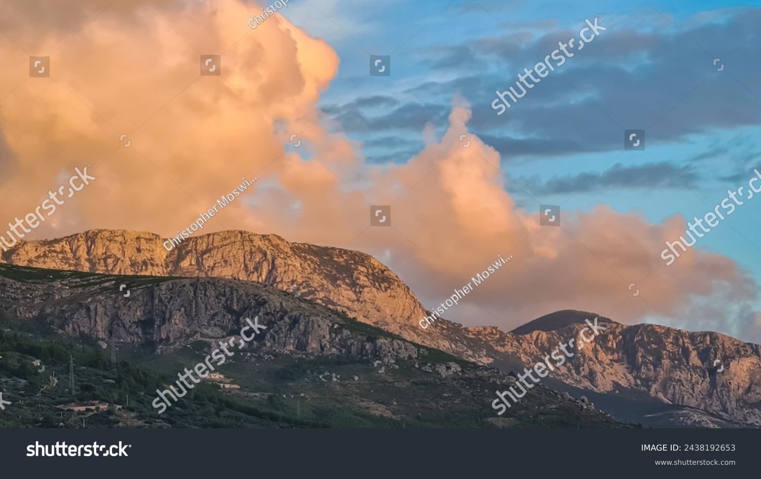 Scenic sunset view of cloud covered Biokovo mountains in majestic Dinaric Alps seen from Makarska, Split-Dalmatia, Croatia, Europe. Coastline of Makarska Riviera. Hiking in the Balkans. Wanderlust #2438192653