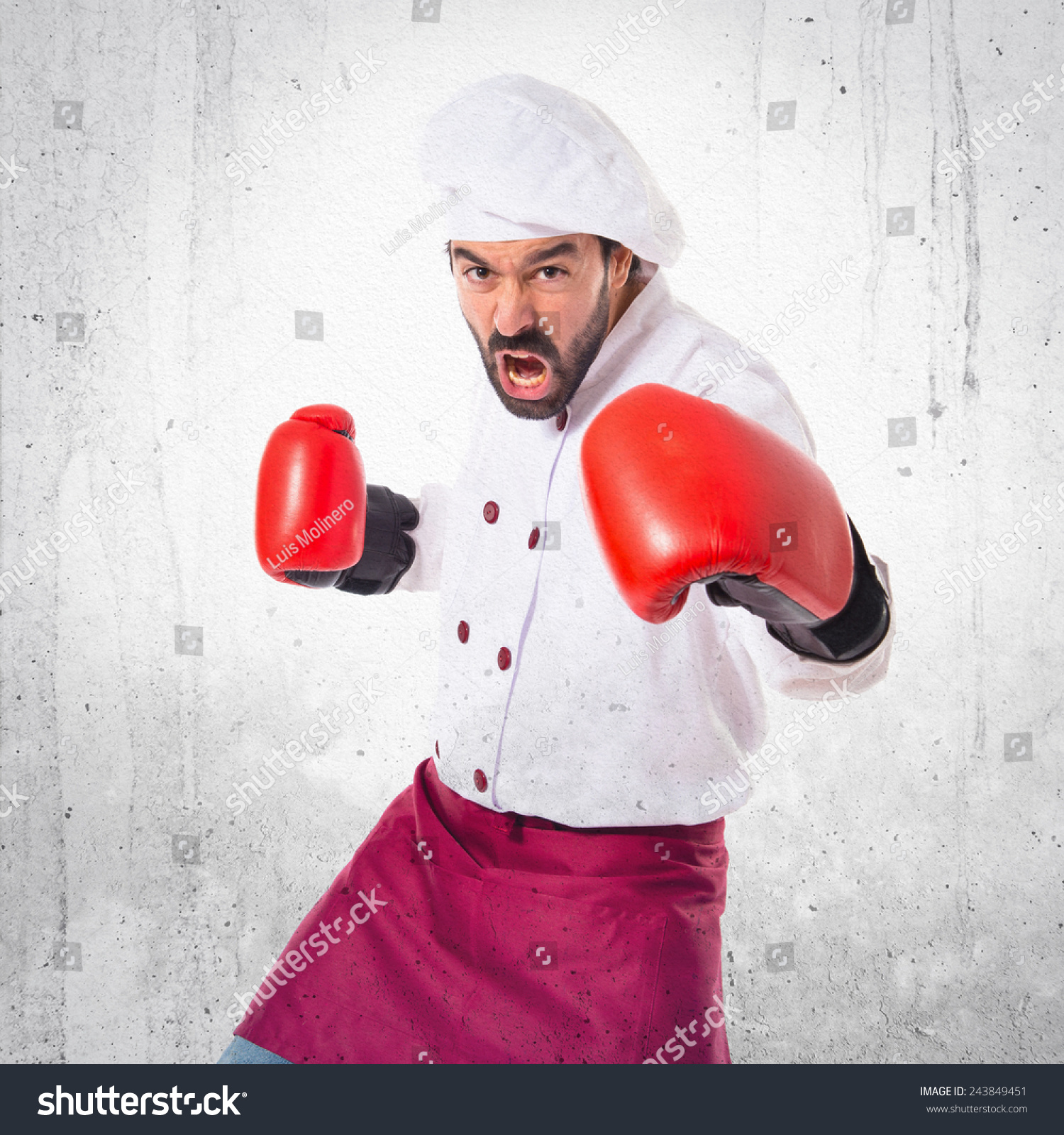Chef fighting with boxing gloves over textured background #243849451