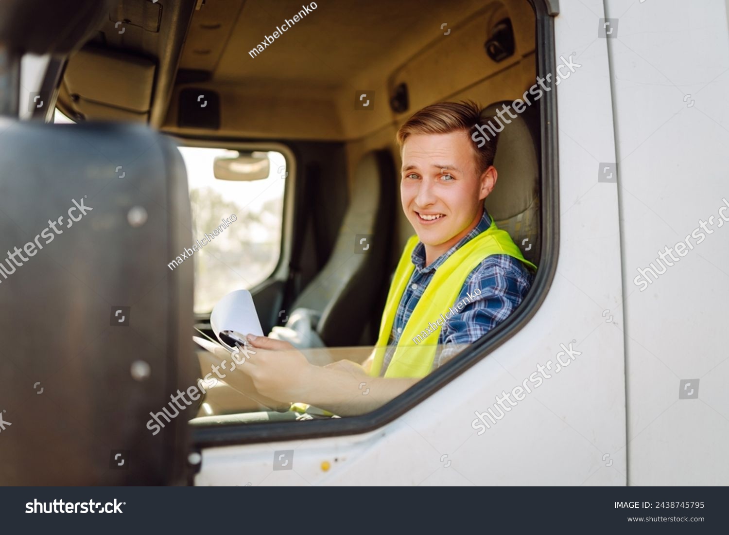 Truck driver job. Logistics - proud driver or forwarder on truck and trailer, on a transshipment point. Transportation service. #2438745795