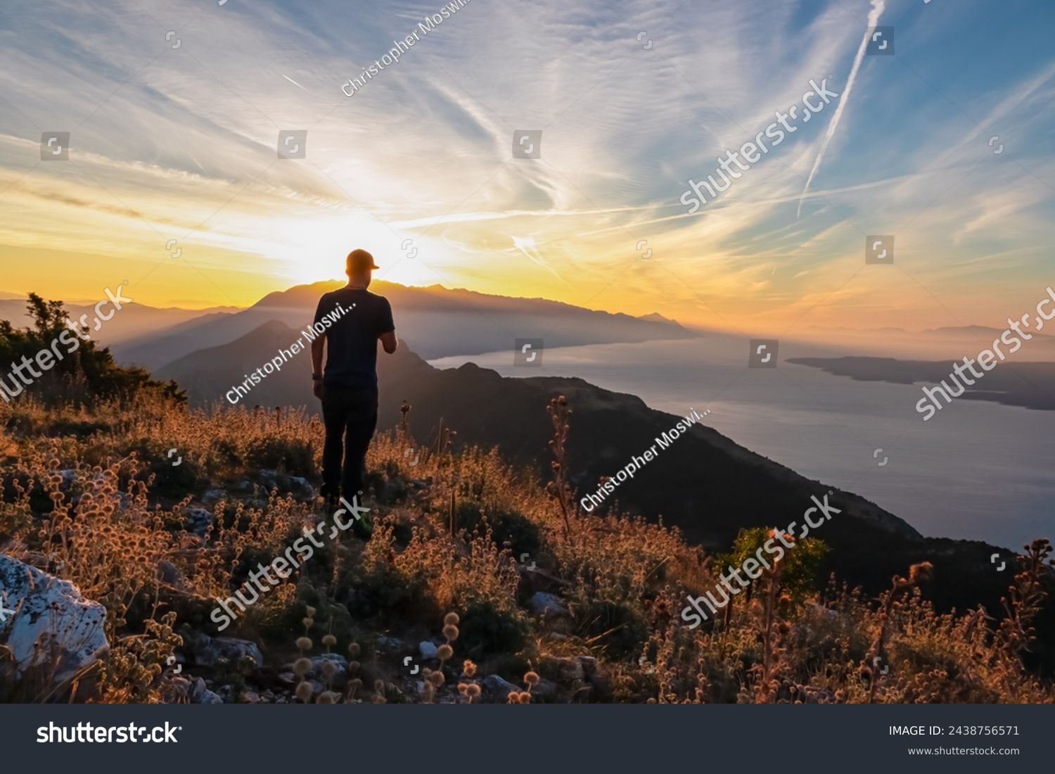 Hiker man with scenic sunrise view from top of mount Kula near Omis, Dinara mountains, Split-Dalmatia, Croatia, Europe. Coastline of Makarska Riviera, Adriatic Sea. Balkans in summer. Biokovo mountain #2438756571