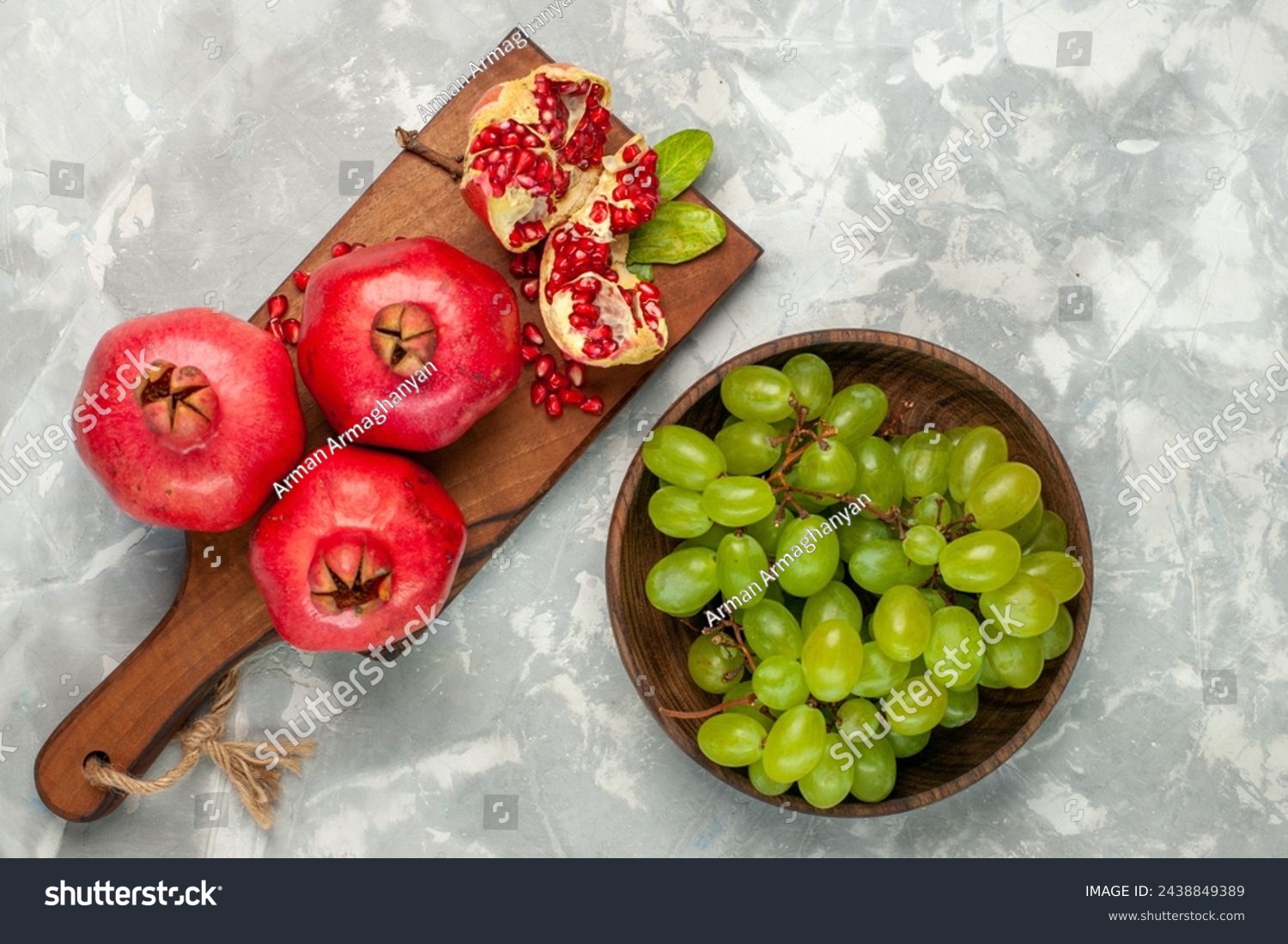 top view fresh red pomegranates sour and mellow fruits with green grapes on light-white desk fruit fresh mellow ripe tree #2438849389