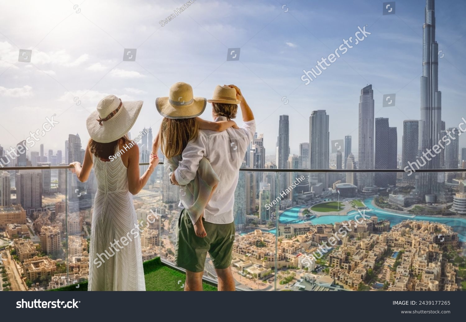 A elegant family on a city break vacation enjoys the panoramic view over the skyline of Dubai, UAE #2439177265