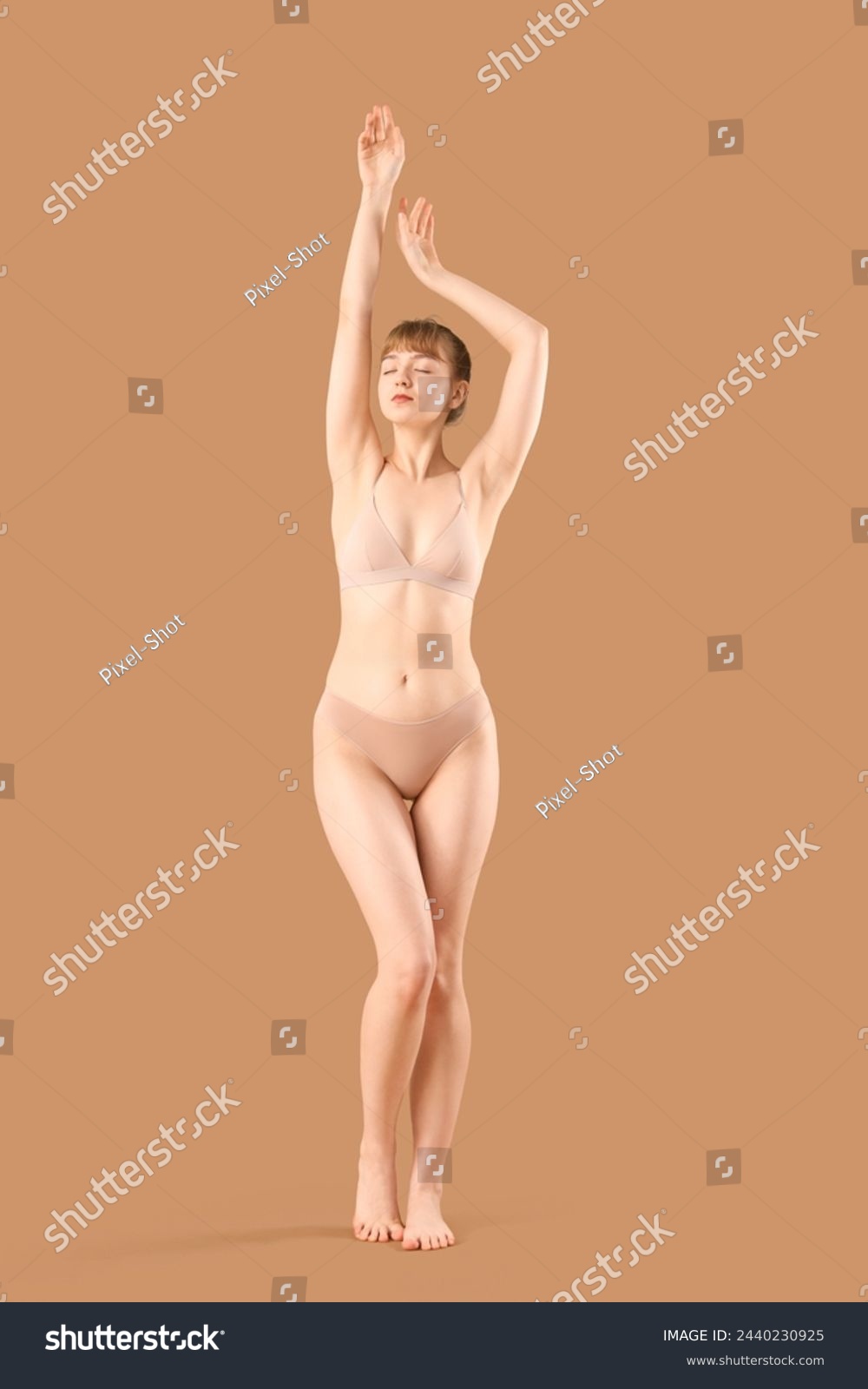 Beautiful young woman in underwear with cellulite problem on beige background #2440230925