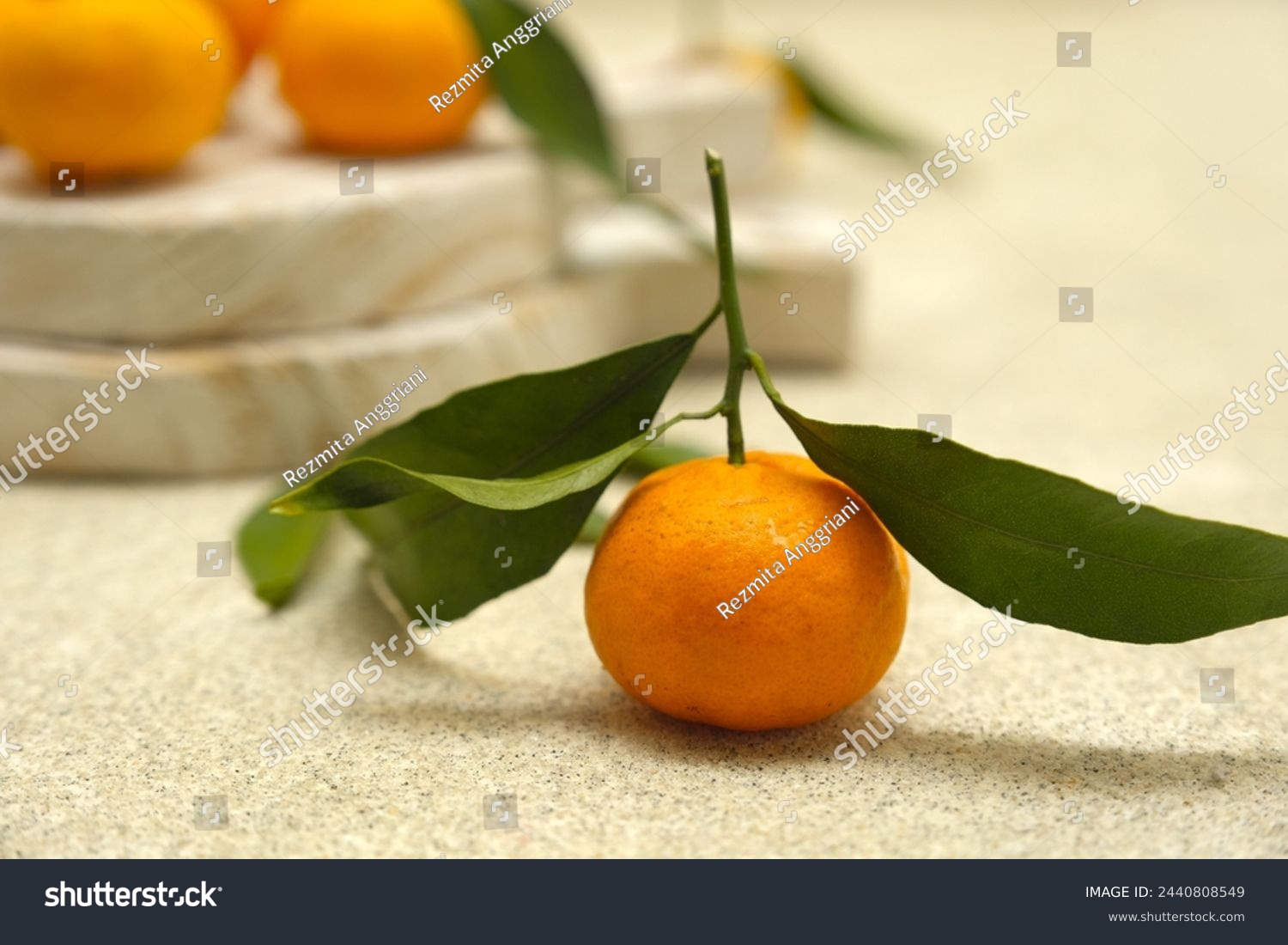 Small orange or tangarine on brown background. Jeruk #2440808549