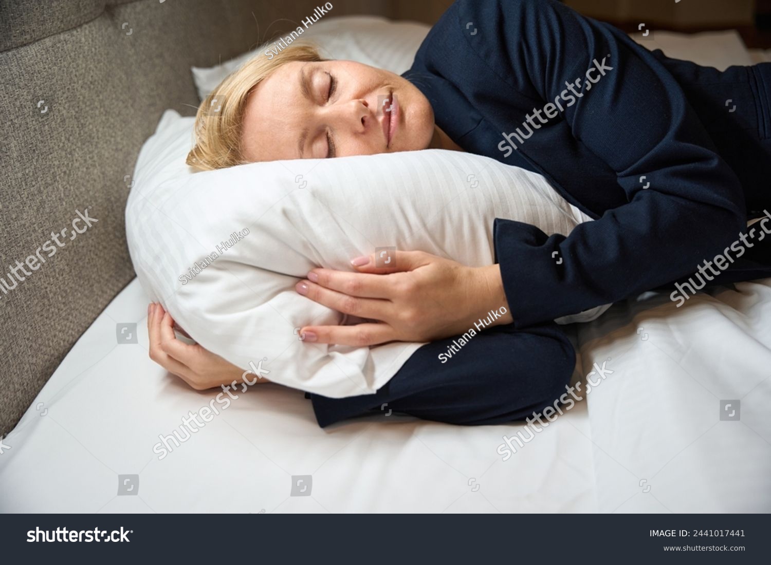 Exhausted businesswoman sleeping peacefully in her bedchamber #2441017441
