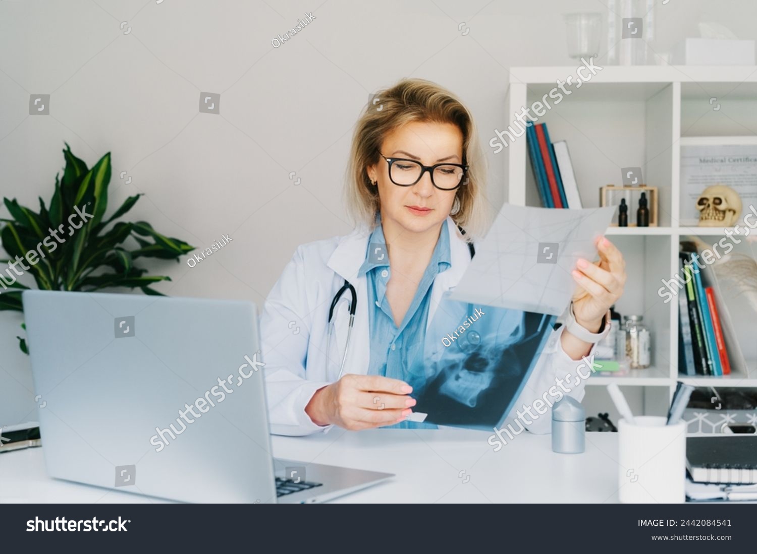 Female doctor makes online video call consult patient on laptop. Middle aged woman therapist videoconferencing for domestic health treatment. Telemedicine concept. Online remote medical appointment. #2442084541