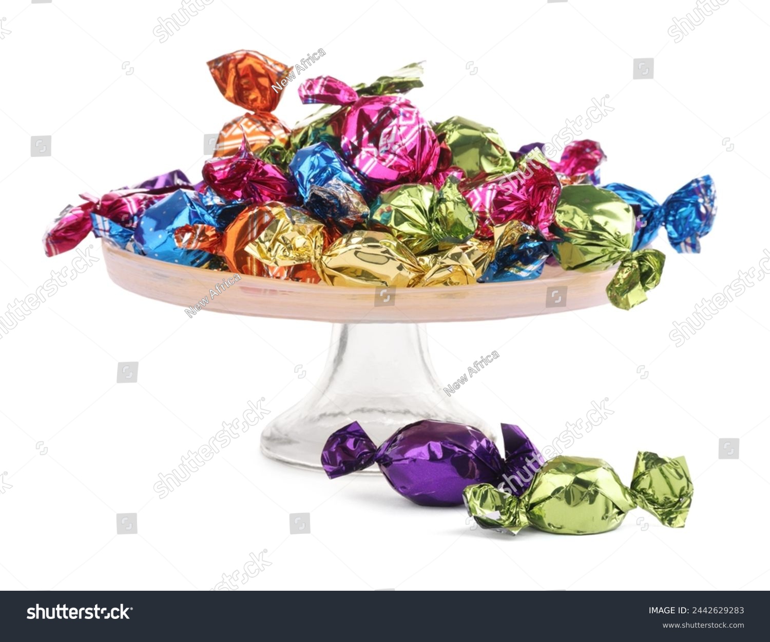 Stand with candies in colorful wrappers isolated on white #2442629283