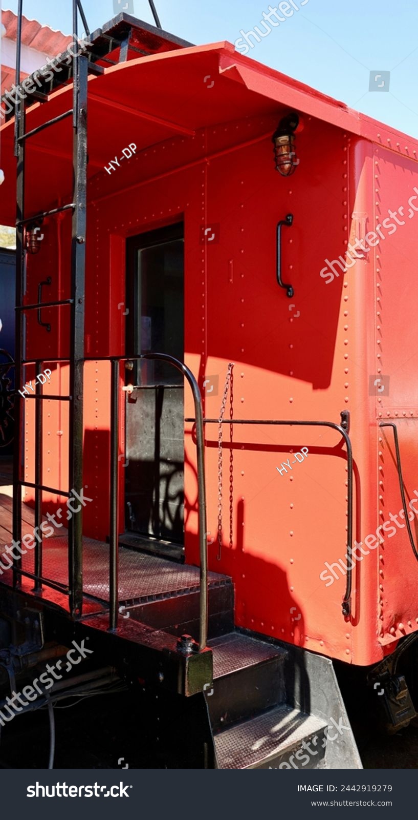 Bright red antique train caboose at the station #2442919279