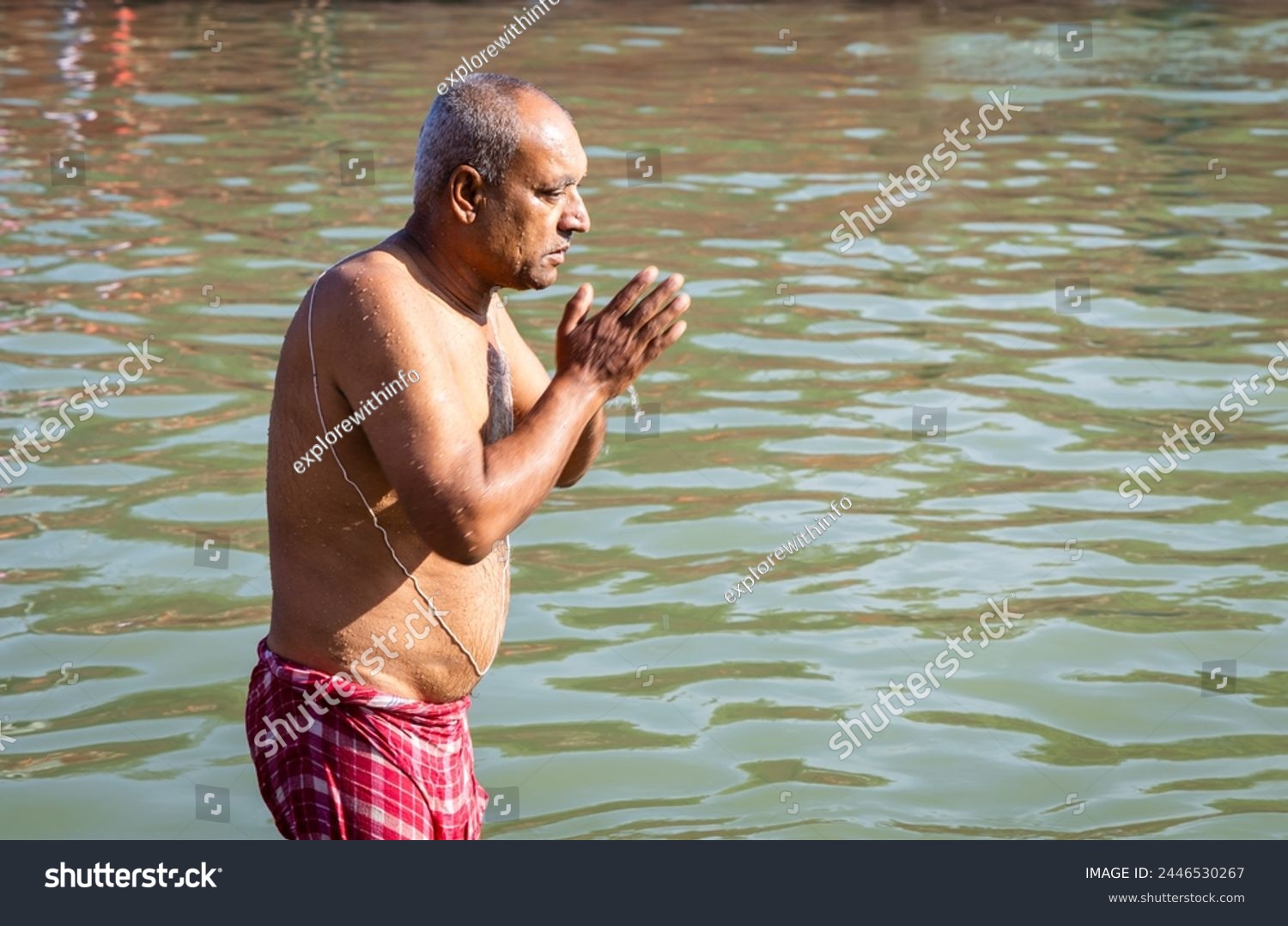devotee praying after bathing in holy river water at morning from flat angle #2446530267