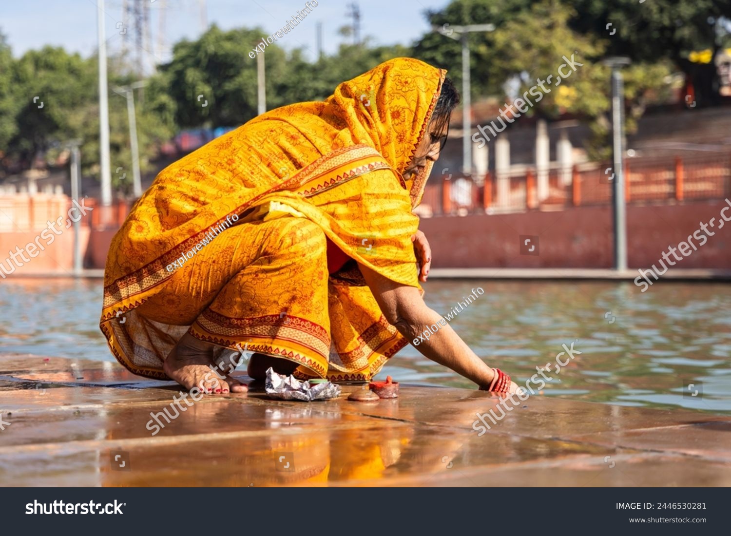 devotee praying for holy god after bathing in holy river water at morning from flat angle #2446530281