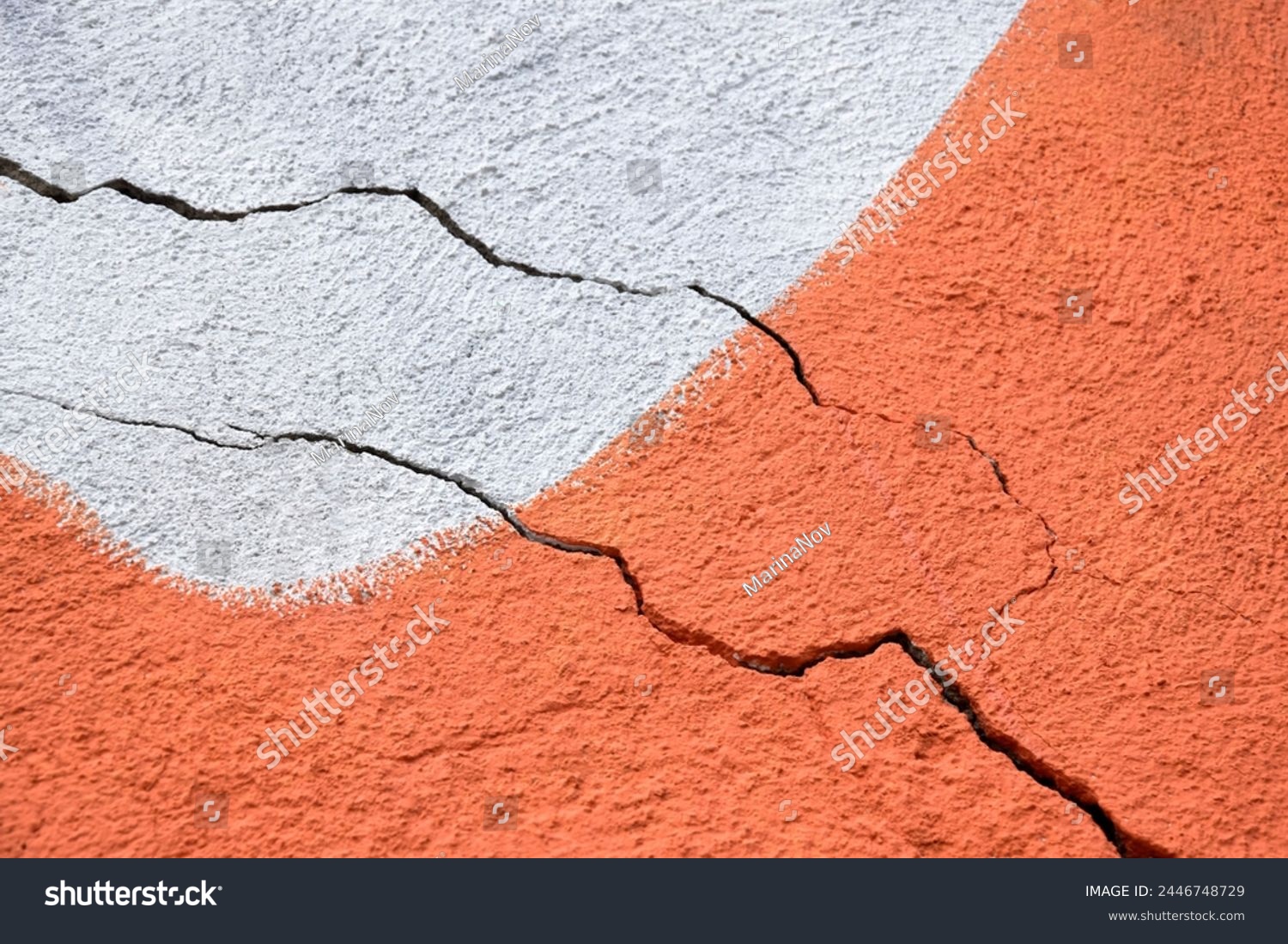 Two big winding descending crack on old multicolored plastering wall. Copy space. Selective focus. #2446748729
