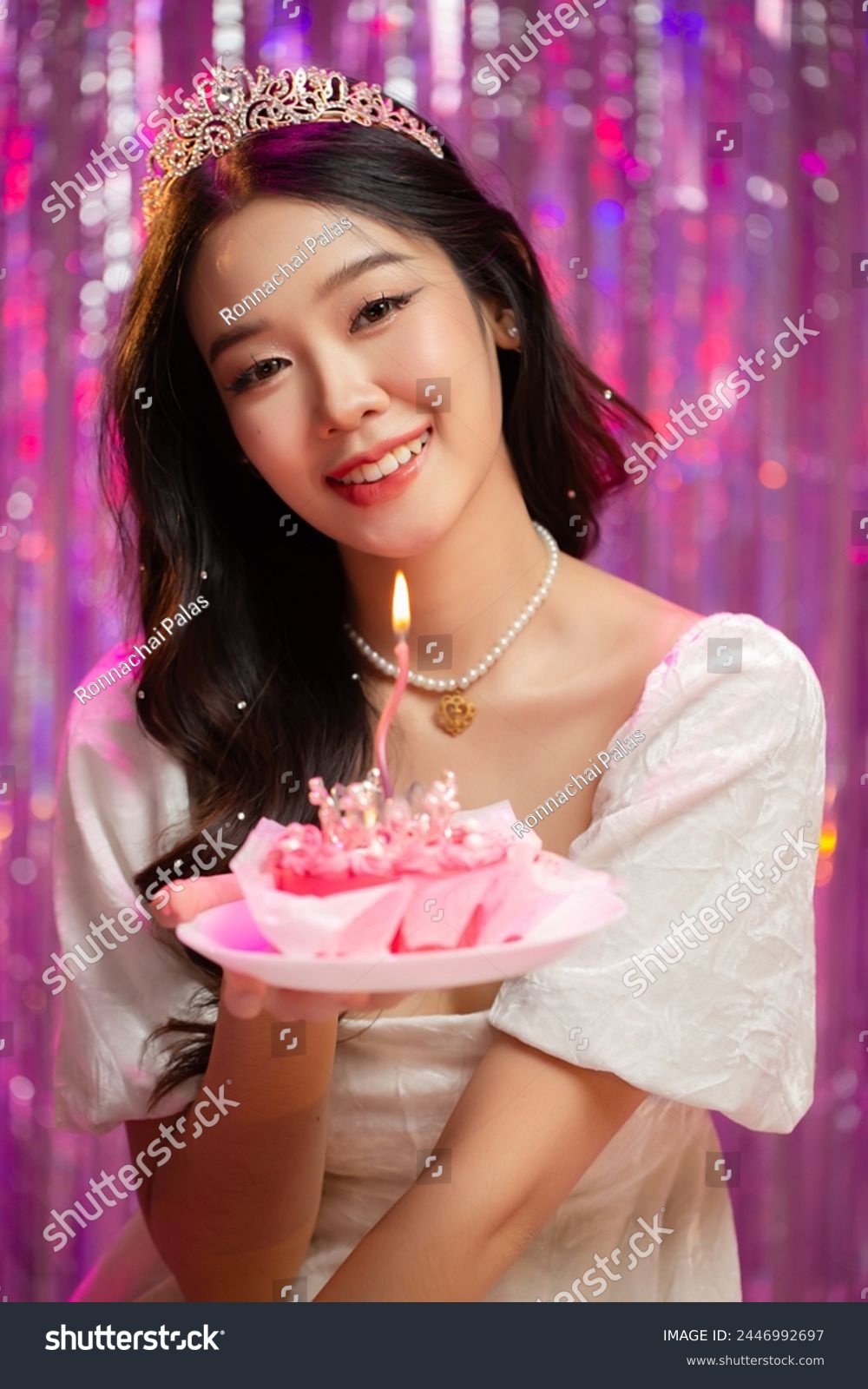 Happy beautiful Asian girl in princess dress showing birthday cake. Birthday princess photography theme is popular in social network. #2446992697