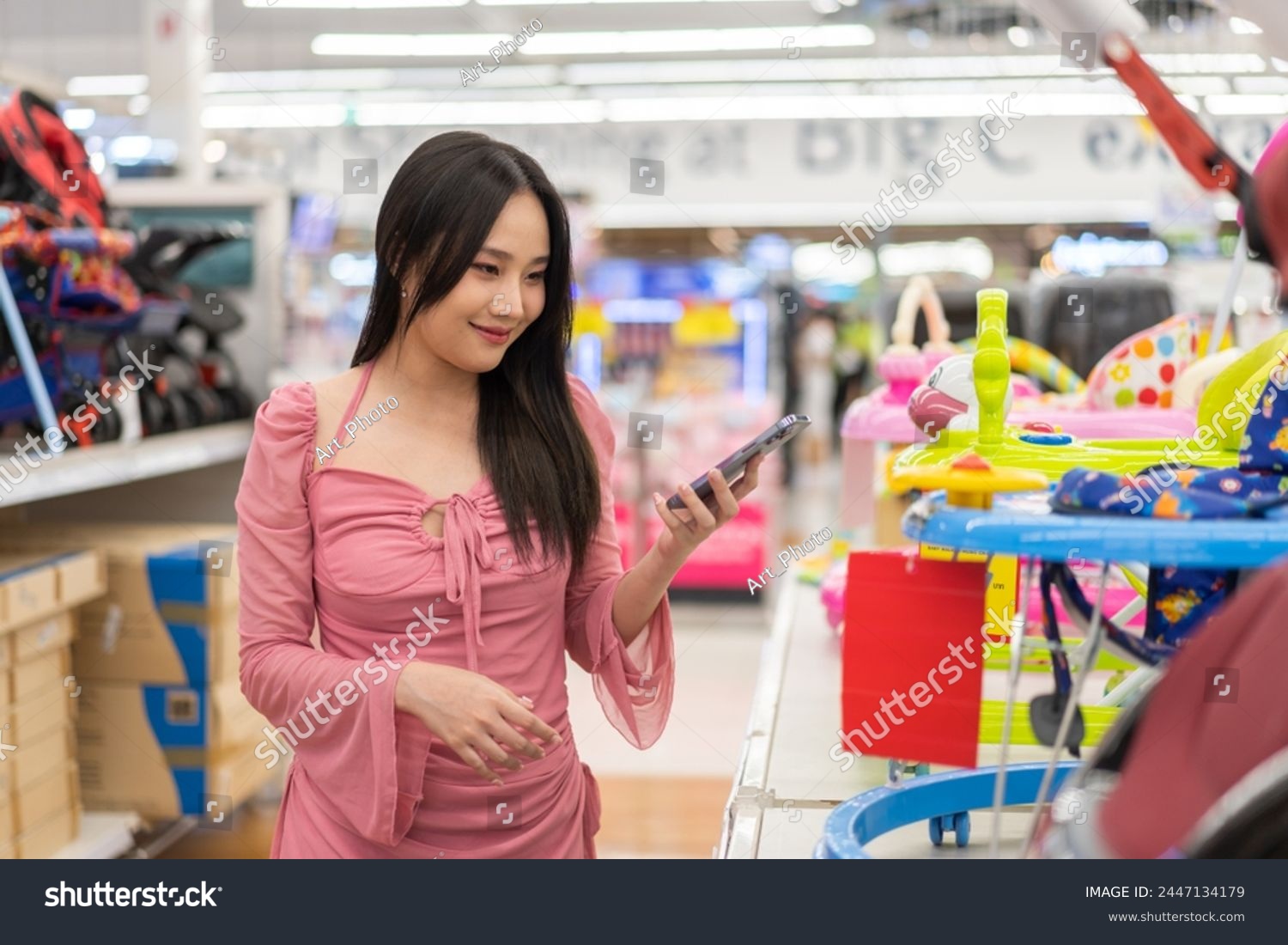Mother woman carefully examines a modern, decision making stroller in spacious baby store, mindful parent, seeking quality and safety in children products family planning, baby care products, shopping #2447134179