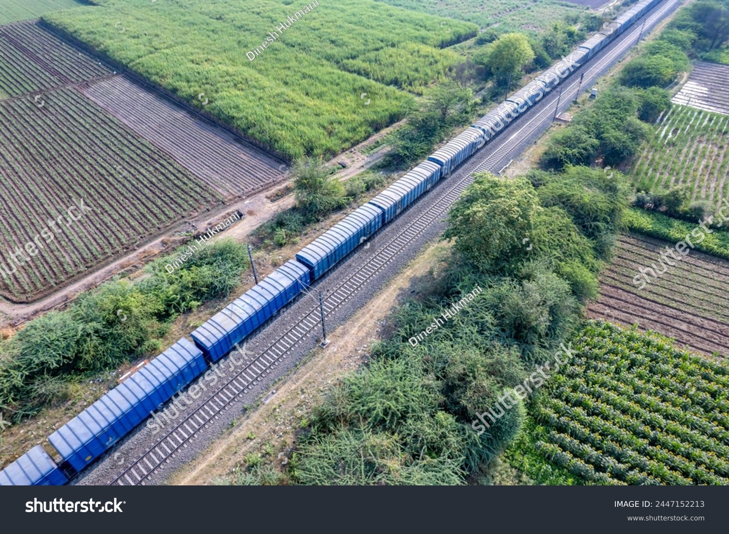 Aerial footage of a freight train in the countryside near Pune India. #2447152213