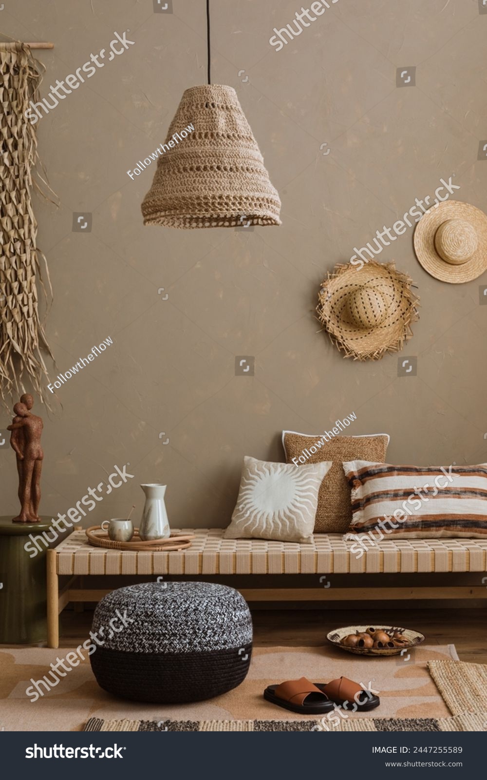 Stylish composition of boho ethno living room with daybed, pillows, hanging decoration, carpet, basket, beige accessories. Home decor. Template.	
 #2447255589