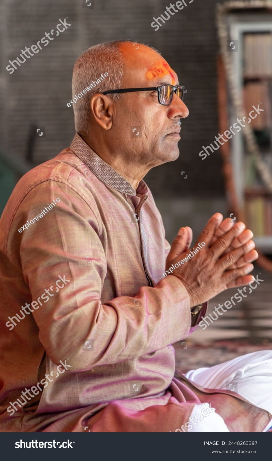 devotee praying for holy god at temple at morning from flat angle #2448263397