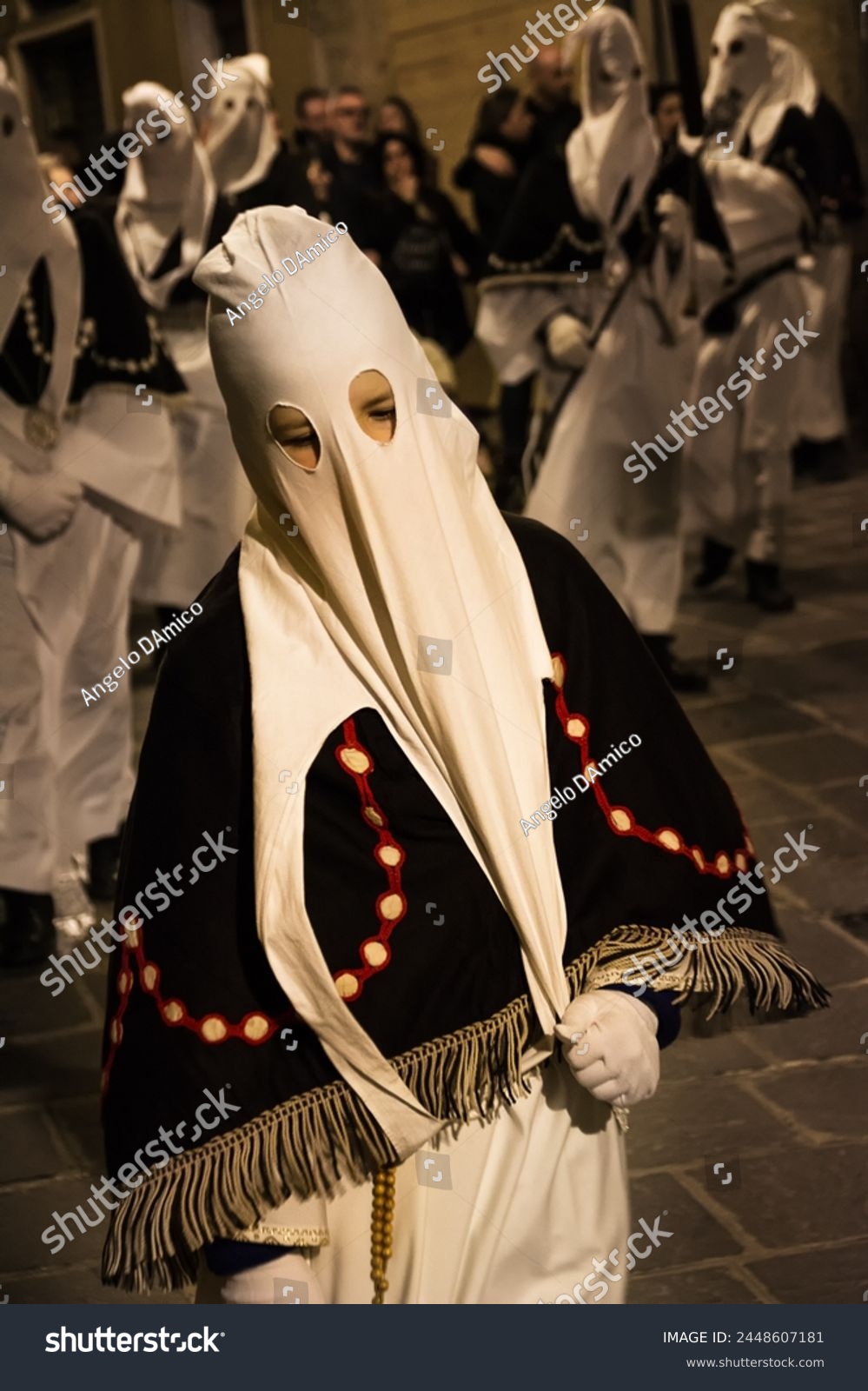 Hooded penitents during the famous Good Friday procession in Chieti (Italy) with their hoods pulled #2448607181
