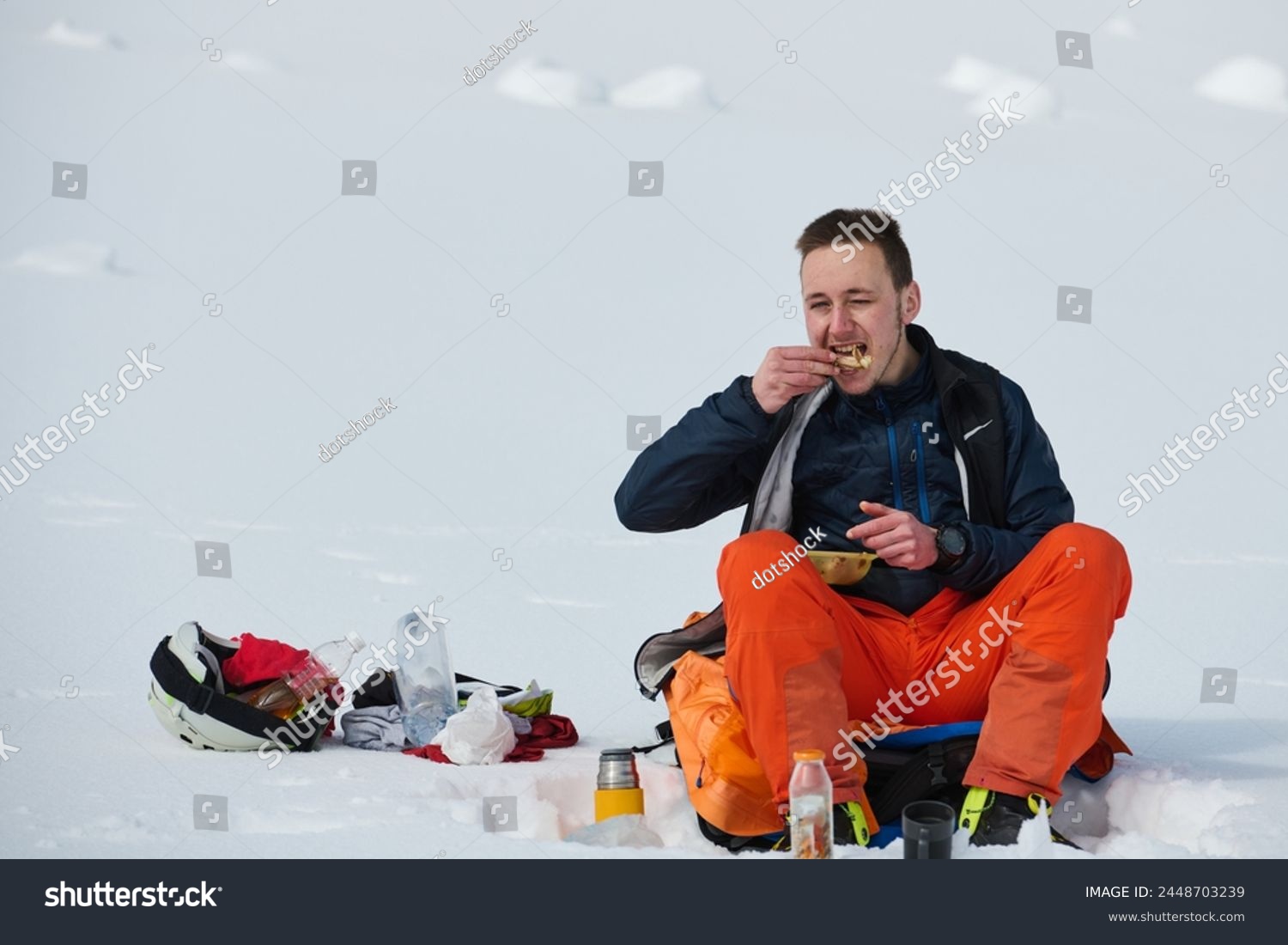 A Skier Takes a Well-Deserved Break to Enjoy the View #2448703239