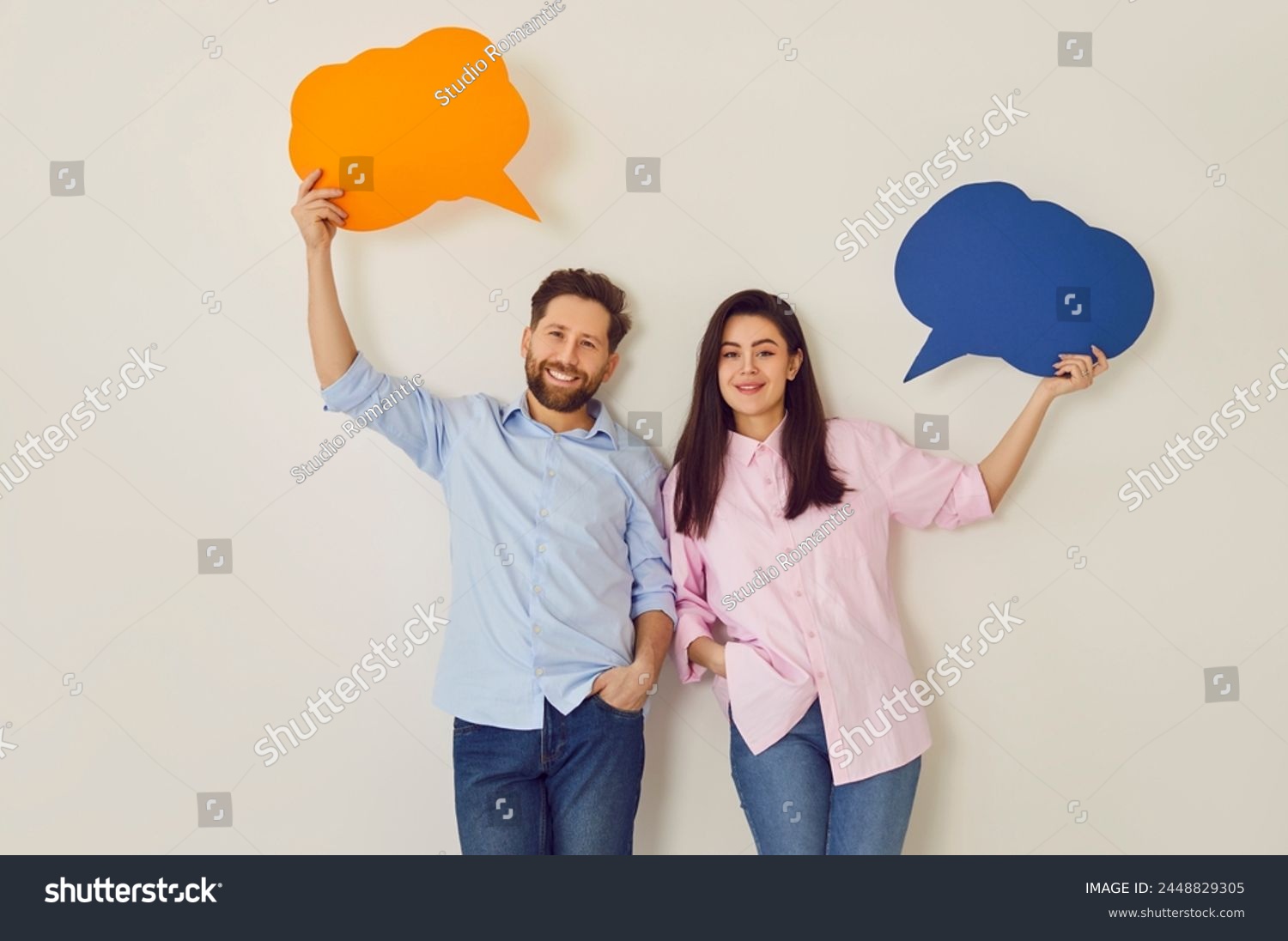 Young happy couple, paper speech balloons above, man, woman pair happy communication, dialog. People interact, information, express feeling, good conversation, discourse, chatting in close relations #2448829305