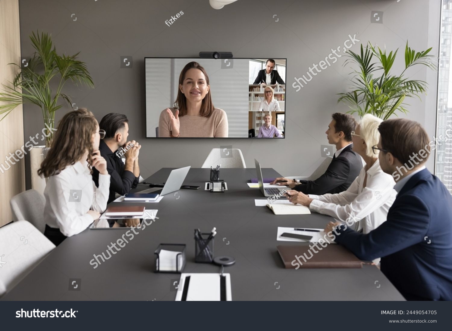 Female leader on screen, provide explanation, informing to teammates at formal virtual meeting. Group of staff listening speech of businesswoman, lead briefing event take part in videocall by business #2449054705