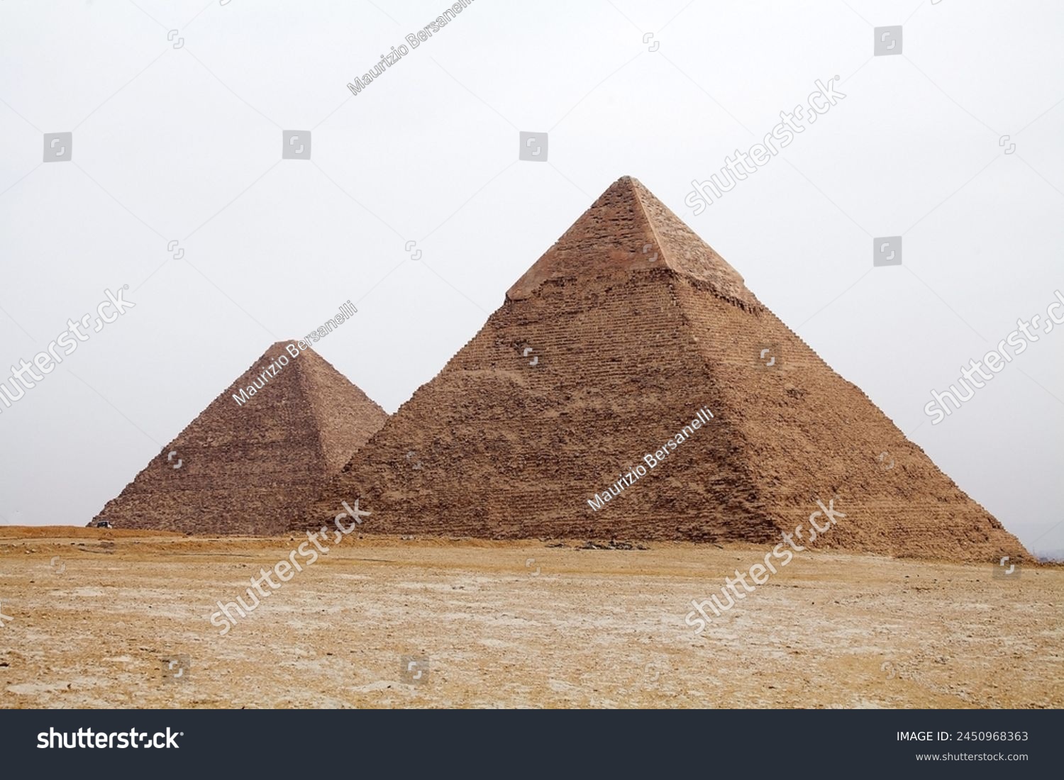 The Great Pyramid and Pyramid of Khefre at the Giza Pyramid Complex in Giza, Egypt, also called the Giza Necropolis. It was built during the Fourth Dynasty of the Old Kingdom #2450968363