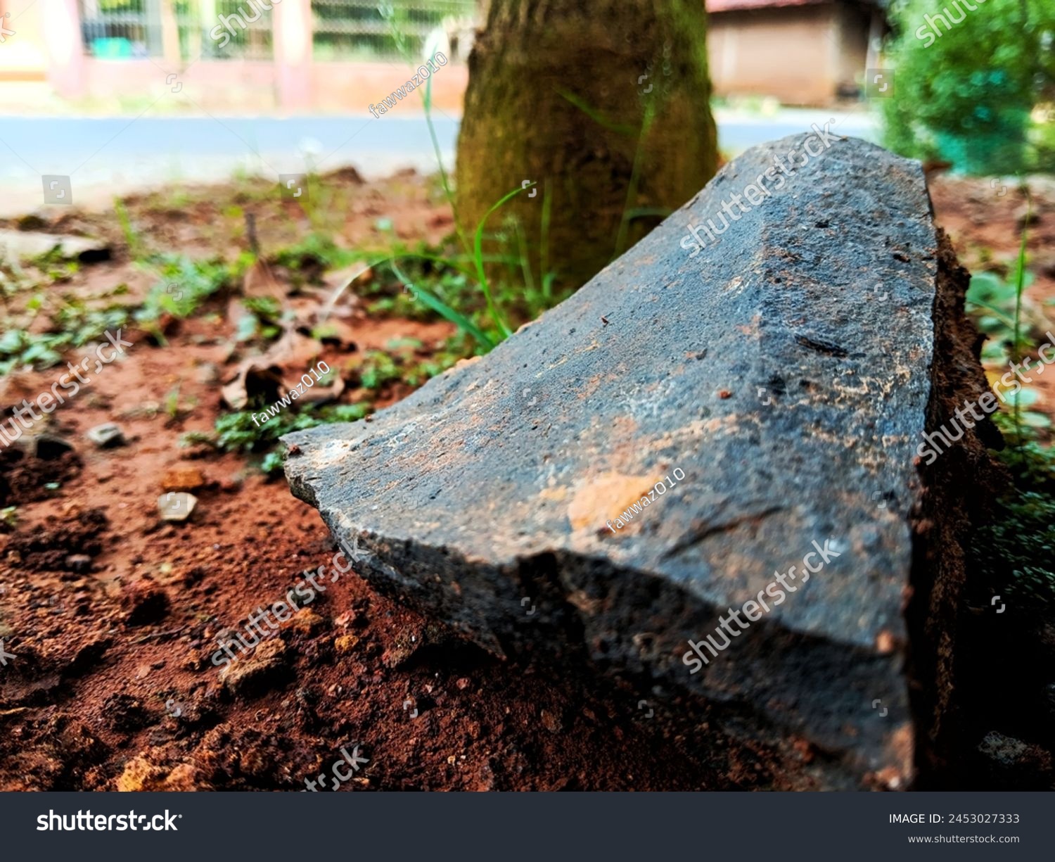 chunks of elephant rock in the yard of the house. One type of split stone that has strong and sturdy properties. Usually used as a basic material for building houses #2453027333